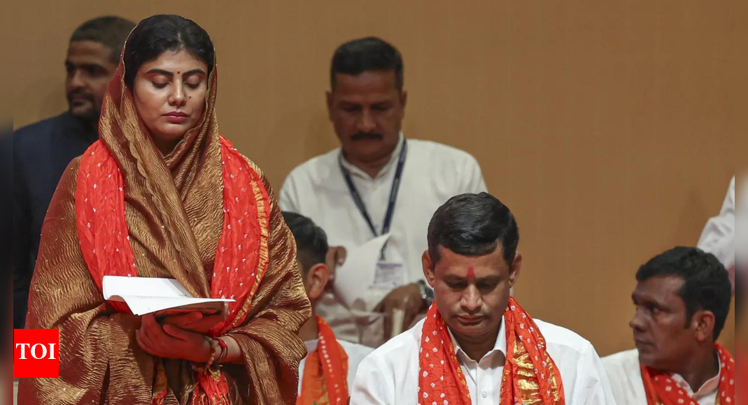 MLA Rivaba Jadeja, wife of cricketer Ravindra Jadeja, takes oath during the swearing-in ceremony of the new Gujarat cabinet, in Gandhinagar, Gujarat. Other political leaders were also present. (PTI Photo)) NEW DELHI: Gujarat chief minister Bhupendra Patel on Friday carried out a major cabinet reshuffle, inducting 19 new ministers and retaining six from his earlier team. Harsh Sanghavi was elevated as deputy chief minister, while Rivaba Jadeja, wife of cricketer Ravindra Jadeja, was also included in the council of ministers.Following the expansion, the council now has 26 members, including the chief minister, up from 17 earlier. Gujarat, with a 182-member assembly, can have a maximum of 27 ministers, or 15% of the total strength of the House.Portfolios Allocated To Gujarat’s New Ministers After Major Cabinet ReshuffleThe cabinet reshuffle comes two years before the next state assembly elections in 2027 and months ahead of local body polls.Governor Acharya Devvrat administered the oath of office and secrecy to the new ministers and those elevated to cabinet rank or assigned independent charge.Key pointsCM Bhupendra Patel keeps General Administration, Administrative Reforms and Training and other departments.Deputy CM Harsh Sanghavi gets Home, Police Housing, Jail, Border Security, Gram Rakshak Dal, Civil Defence, Prohibition and Excise, Transport, Law and Justice, Sports and Youth Services and other departments.Minister Kanubhai Mohanlal Desai gets Finance, Urban Development and Urban Housing.Minister Rushikesh Ganeshbhai Patel gets Energy and Petrochemicals, Panchayat and Rural Housing, Legislative and Parliamentary Affairs.Minister Rivaba Ravindrasinh Jadeja gets Primary, Secondary and Adult Education.Here’s the full listChief ministerBhupendrabhai Rajnikant Patel — General Administration, Administrative Reforms and Training, Planning, Non-Resident Gujaratis’ Division, Revenue and Disaster Management, Roads and Buildings and Capital Projects, Narmada, Kalpasar, Mines and Minerals, Ports, Information and Broadcasting, All Policies and All Subjects not allotted to other Ministers.Deputy chief ministerHarsh Rameshkumar Sanghvi — Home, Police Housing, Jail, Border Security, Gruh Rakshak Dal, Gram Rakshak Dal, Civil Defence, Prohibition and Excise, Transport, Law and Justice, Sports and Youth Services, Cultural Activities, Coordination of Voluntary Organisations, Industries, Salt Industries, Micro, Small and Medium Industries, Printing and Stationery, Tourism and Pilgrimage Development, Civil Aviation.MinistersKanubhai Mohanlal Desai — Finance, Urban Development and Urban Housing.Jitendrabhai Savjibhai Vaghani — Agriculture and Farmers Welfare, Cooperation, Fisheries, Animal Husbandry and Cow Breeding.Rushikesh Ganeshbhai Patel — Energy and Petrochemicals, Panchayat and Rural Housing, Legislative and Parliamentary Affairs.Kunvarjibhai Mohanbhai Bavaliya — Labour, Skill Development and Employment, Rural Development.Nareshbhai Maganbhai Patel — Tribal Development, Khadi, Cottage Industries and Rural Industries.Arjunbhai Devabhai Modhwadia — Forests and Environment, Climate Change, Science and Technology.Pradyuman Gunabhai Vaaja — Social Justice and Empowerment, Primary, Secondary and Adult Education, Higher and Technical Education.Ramanbhai Bhikhhabhai Solanki — Food, Civil Supplies and Consumer Affairs.MInisters Of StateIshwarsinh Thakorbhai Patel — Water Resources, Water Supply (Independent Charge).Praful Chhaganbhai Panseriya — Health, Family Welfare and Medical Education (Independent Charge).Manisha Rajivbhai Vakil — Women and Child Development (Independent Charge), Social Justice and Empowerment (State Minister).Parshottambhai Odhavjibhai Solanki — Fisheries.Kaantilal Shivlal Amrutiya — Labour, Skill Development and Employment.Rameshbhai Bhurabhai Katara — Agriculture and Farmers Welfare, Cooperation, Animal Husbandry and Cow Breeding.Smti Darshanaben Mukeshbhai Vaghela — Urban Development and Urban Housing.Kaushikbhai Kaantibhai Vekariya — Law and Justice, Energy and Petrochemicals, Legislative and Parliamentary Affairs.PravinKumar Gordhanbhai Maali — Forests and Environment, Climate Change, Transport.Jayarambhai Chembabhai Gamit — Sports and Youth Services, Cultural Activities, Coordination of Voluntary Organisations, Industries, Salt Industries, Micro, Small and Medium Industries, Printing and Stationery, Tourism and Pilgrimage Development, Civil Aviation.Trikambhai Bijalbhai Changa — Higher and Technical Education.Kamleshbhai Rameshbhai Patel — Finance, Police Housing, Jail, Border Security, Gruh Rakshak Dal, Gram Rakshak Dal, Civil Defence, Prohibition and Excise.Sanjaysinh Vijaysinh Mahida — Revenue and Disaster Management, Panchayat and Rural Housing, Rural Development.Punambhai Dhanabhai Baranda — Tribal Development, Food, Civil Supplies and Consumer Affairs.Swarupji Dardasji Thakor — Khadi, Cottage Industries and Rural Industries.Rivaba Ravindrasinh Jadeja — Primary, Secondary and Adult Education.About the AuthorTOI News DeskThe TOI News Desk comprises a dedicated and tireless team of journalists who operate around the clock to deliver the most current and comprehensive news and updates to the readers of The Times of India worldwide. With an unwavering commitment to excellence in journalism, our team is at the forefront of gathering, verifying, and presenting breaking news, in-depth analysis, and insightful reports on a wide range of topics. The TOI News Desk is your trusted source for staying informed and connected to the ever-evolving global landscape, ensuring that our readers are equipped with the latest developments that matter most.”Read MoreEnd of ArticleFollow Us On Social MediaVideosPortfolios Allocated To Gujarat’s New Ministers After Major Cabinet ReshufflePakistan Seeks Trump’s Intervention After Afghan-Taliban Forces Humiliate Pak Army In Border ClashDense Chhattisgarh Forests No Longer Safe For Naxals, Over 200 Maoists Lay Down ArmsChina Breaks Silence on Border Clash, Follows India To Tell Pakistan, Afghanistan to End CrisisPakistan-Afghanistan Border Tensions Explode Ahead Of Ceasefire Deadline: Blast Kills 7 Pak Soldiers‘Jungle Raj’: Amit Shah Slams RJD For Fielding Shahabuddin’s Son In Bihar ElectionsAir Power, Tech Will Define Future Wars: Defence Secretary Rajesh Singh at Tejas Mk1A Showcase EventHAL Celebrates Maiden Flight of the First Tejas Mk1A Fighter Jet Manufactured at its Nashik FacilityRahul Gandhi Meets Family of Lynched Dalit in UP, Claims Govt Threatened Them and Calls for ActionTwo-Front War Loading: Pakistan Defence Minister Khawaja Asif Blames India in Afghan ‘Proxy War’123 Photostories  10 mind-blowing superpowers of chameleonsFrom Archana Puran Singh’s nostalgic Dehradun Diwali to fun housie nights with staff – Archana and Parmeet Sethi’s cherished family Diwali memories3 superfoods to control cholesterol and the right way to consume them6 ways to set healthy boundaries without pushing others awayFun facts about ‘Alpha’ star Sharvari WaghDiwali 2025: 15 types of traditional Pooris to try this festive seasonDhanteras 2025: 5 trendy gold mangalsutra designs to buy this festive season for a stylish lookDiwali 2025: Sonakshi Sinha’s stylish festive fashion guide for the seasonExclusive – Rise and Fall Winner Arjun Bijlani opens up about his victory, breakdown, meeting his son Ayaan and reacts to Akriti Negi showing him middle fingerPersonality Test: What your favourite sleeping position reveals about your true nature and hidden emotions123Hot PicksGold Silver PriceRiyadh AirBihar Election 2025Gold rate todaySilver rate todayPublic Holidays OctoberBank Holidays OctoberTop TrendingChris Evert vs Martina Net WorthJohn BoltonPokemon All Mega Evolutions RankedJoe Flacco WifeRonda RouseyAaron Rodgers PittsburghBlake LivelyRussell WilsonHarvard CrimsonZack Yadegari