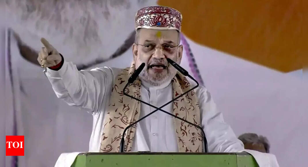 Union home minister Amit Shah launched a strong attack on the INDIA bloc in Bihar, accusing Congress and RJD leaders of dynastic politics and corruption. He asserted that the ambitions of Sonia Gandhi and Lalu Prasad Yadav to see their sons in top posts would fail, as the Prime Minister and Chief Minister positions are not vacant. Amit Shah (Photo: PTI) NEW DELHI: Union home minister Amit Shah launched a sharp attack on the INDIA bloc during a series of rallies in Bihar on Wednesday, accusing Congress leader Sonia Gandhi and RJD supremo Lalu Prasad Yadav of promoting dynastic politics and corruption. Shah took sharp digs at both leaders, saying their ambitions to see their sons as chief minister and prime minister would fail, as “both the posts are not vacant.”In Khagariya, Amit Shah Frames Bihar Poll As Choice Between NDA’s Five Pandavas And RJD’s Jungle Raj’PM, CM seats not vacant’Addressing a crowd in Begusarai, Shah said, “The BJP has given tickets to many youngsters for the Bihar assembly polls, but the RJD and Congress have not, as Lalu ji wants to make his son Tejashwi to become the Chief Minister and Sonia Gandhi wants her son, Rahul to become the Prime Minister.”He went on to mock the opposition leadership, saying, “I want to say this to Sonia ji and Lalu ji — ‘Bihar mein na CM pad khali hai, Delhi mein PM pad khali hai. Aapke beto ka number nahi lagne wala hai’.”Shah also branded the opposition alliance as a corrupt coalition, remarking that the Mahagathbandhan was actually a ‘thug bandhan,’ led by leaders mired in scams.’Lalu and Rahul protect infiltrators’Shah further accused the RJD-Congress alliance of shielding infiltrators in Bihar’s voter lists. Taking aim at Rahul Gandhi, he said, “Rahul Baba had come here a month and a half ago. Now, after a month, he has come again today. When he came earlier, he had taken out a ‘Ghuspaithiya Bachao Yatra’.”Shah asked the crowd, “Today I have come to ask the people of Begusarai, and the followers of Lord Parashuram: should there be Bangladeshi infiltrators on Bihar’ s voter lists? Both Lalu (Yadav) and Rahul (Gandhi) have become protectors of Bangladeshi infiltrators. But today I promise you that our four candidates will identify them and remove every single infiltrator from the soil of Bihar.”He continued, “An infiltrator takes a share of our ration and grain, takes work meant for our labourers, and with their vote creates an anti-India government. Lalu and Rahul are protectors of infiltrators on the voter lists. Tell me: should the infiltrators be removed or not? Can Rahul remove them? Only Narendra Modi can remove them.”‘This election is not about making someone CM’Shah described the upcoming 2025 Bihar Assembly elections as a battle for the state’ s future, stating that, “The upcoming Bihar election of 2025 is not about making someone an MLA, a minister, or even a chief minister. This election is to save Bihar from jungle raj (lawlessness). We have witnessed jungle raj before, Begusarai was once an industrial district, but one by one, all industries on this land disappeared,” he said.His remarks come amid uncertainty over the NDA’s chief ministerial face, with the opposition mocking the alliance over it. “Bihar’ s soil was soaked in blood because of heinous crimes. Industries of crime, murder, ransom, extortion, and abduction began to flourish. For 15 years, Lalu and Rabri devastated the land of Bihar. Now, after 20 years, that same jungle raj is returning in the form of Tejashwi and Rahul’ s alliance,” the Union minister added.Cautioning voters, Shah said, “People of Bihar, be careful, one mistake will push Bihar back by 20 years. But if you make the right decision, under the leadership of Modi ji, a ‘Viksit Bihar’ will be built.”Shah praises Nitish-Modi duoAddressing another rally in Samastipur, Shah continued his attack on the opposition, targeting Lalu and Rabri over multiple corruption cases.”Lalu and Rabri Devi were involved in the fodder scam, land-for-jobs scam, hotel scam, export scam, and disproportionate assets scam. Can this ‘Mahathugbandhan’ do any good for Bihar? Only the Nitish Kumar and Narendra Modi duo can bring development to the state,” he said.Dismissing any doubts over NDA unity, Shah described the alliance as ‘paanch paandav,’ a strong team of five parties, and asserted that they would secure a “historic victory” in the coming polls.’They want to snatch Karpoori Thakur’s legacy’Shah also accused the opposition of attempting to politicise the legacy of former Bihar chief minister Karpoori Thakur. “Modi ji bestowed Bharat Ratna upon Jannayak Karpoori Thakur. Now, they (opposition) want to take away the title from Karpoori ji. We will not let this happen. People have seen the real face of Congress that had prevented Babu Jagjivan Ram from becoming the PM,” he alleged.’Should Article 370 have been revoked?’Speaking later in Darbhanga, Shah highlighted Modi government’s work in both Ayodhya and Kashmir, stating that, “Here, a temple of Sita Mata is also being built. Brothers and sisters, tell me Kashmir is ours, isn’t it? Why is there any doubt? I am asking clearly: Is Kashmir part of India or not? And should Article 370 have been revoked or not?”He further alleged that, “For 70 long years, a Congress-led government, along with leaders like Lalu, kept Article 370 in place. But Prime Minister Modi abolished Article 370 forever on August 5, 2019. There was a time when terrorists would leave India’ s soil bloodied…But then a surgical strike was carried out, the second time an air strike was conducted, and the third time, Operation Sindoor was executed, during which Pakistan was cleaned up.”About the AuthorTOI News DeskThe TOI News Desk comprises a dedicated and tireless team of journalists who operate around the clock to deliver the most current and comprehensive news and updates to the readers of The Times of India worldwide. With an unwavering commitment to excellence in journalism, our team is at the forefront of gathering, verifying, and presenting breaking news, in-depth analysis, and insightful reports on a wide range of topics. The TOI News Desk is your trusted source for staying informed and connected to the ever-evolving global landscape, ensuring that our readers are equipped with the latest developments that matter most.”Read MoreEnd of ArticleFollow Us On Social MediaVideosAmid Rising Waters and Discontent, Supaul Voters Turn the Bihar Election into a Fight for ChangeChirag Paswan Accuses Owaisi of Dividing Muslims Through Fear Politics’If You Ask PM To Dance…’: Rahul Gandhi Targets Modi, Says BJP Remote Controls Nitish KumarUP CM Yogi Adityanath Targets RJD’s ‘Osama’ in Shahabuddin’s Stronghold, Sparks Ram Temple ShowdownPak Minister Khawaja Asif Accuses Afghanistan Acting Under India’s Influence, Issues Brutal WarningDonald Trump Calls PM Modi ‘Killer’, Asim Munir a ‘Great Fighter’, Repeats India-Pak Ceasefire ClaimAmazon Launches Largest Layoff Drive Yet, Cutting 30,000 Corporate Positions to Boost EfficiencyIndia, EU Narrow Differences As Piyush Goyal Wraps High-Stakes Brussels Push For Swift Trade Deal“Even Ate The Animals’ Fodder” Prashant Kishore Slams Tejashwi After INDIA Bloc’s Bihar ManifestoOne Dead, Thousands Evacuated as Cyclone Montha Tears Through Andhra and Odisha123 Photostories  Do female students outperform boys? Here’s what US teens think about gender bias in schoolsTimes when Bigg Boss Malayalam 7 contestants mastered the art of spoiling the tasksHow to stop hair fall fast: Doctor shares 7 tips to follow for 21 daysVelvet is back and Sreeleela just gave it a modern makeover with her sharara20 striking photos show Cyclone Montha’s approach to Andhra Pradesh coast at 100kmph8 effective ways to repel aphids, flies, and other plant pests naturally8 things to learn from Virat Kohli’s diet and how they can transform healthGen Z takes the reins rewriting Bollywood’s future with fresh energy and fearless visionIn pics: Bigg Boss Malayalam 7 contestant Noora steals hearts with her adorable and stylish looks‘Stree’ to ‘Bulbbul’: Bollywood’s best movies for Halloween night123Hot PicksCyclone MonthaBank Holiday TodayBihar Election 2025Gold rate todaySilver rate todayPublic Holidays NovemberBank Holidays NovemberTop TrendingDarshan Singh SahsiPrince HarryPraneeth Kumar UsiripalliAdin RossHurricane MelissaSidney CrosbyPenguin GameMLB Trade RumorsCharles HullFortnite Tips