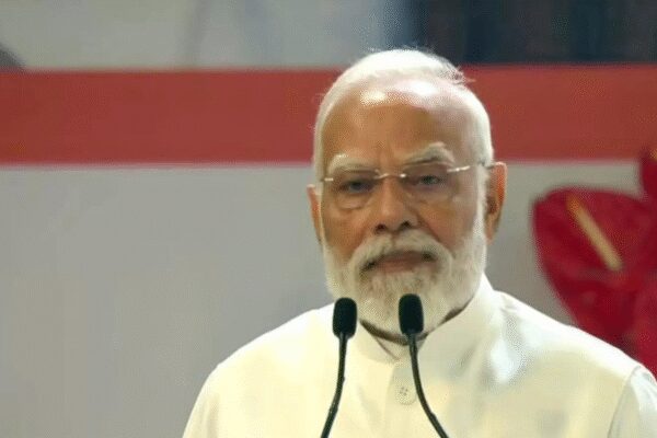 Prime Minister Narendra Modi accused the 1937 Congress government of removing stanzas from Vande Mataram, claiming it fractured the song and sowed seeds of partition. He emphasized the song’s enduring inspiration for nation-building and highlighted India’s civilisational ethos of the nation as a mother and Shakti.  NEW DELHI: Prime Minister Narendra Modi on Friday accused the 1937 Congress of “removing important stanzas” from the original Vande Mataram, saying the decision not only “broke the song into pieces” but also “sowed the seeds of partition.”Speaking at an event marking 150 years of the national song ‘Vande Mataram’ at the Indira Gandhi Indoor Stadium, PM Modi said, “Unfortunately, in 1937, important stanzas were removed from the original Vande Bharat song. Vande Bharat was broken into pieces. This also sowed the seeds of partition. Why was this injustice done? The same divisive ideology remains a challenge for the nation.”PM Modi Calls Vande Mataram A ‘Mantra Of Unity And Courage’ As The Song Completes 150 YearsThe Prime Minister said the song continues to inspire generations and called upon the youth to remain focused on building a Viksit Bharat despite attempts to mislead them. “On our way to Viksit Bharat, we will find people who misguide us. People with a pessimistic outlook will try to sow doubt in our minds. In such times, Vande Mataram inspires us. How can a mother who has crores of children be weak? Bharat Mata has 140 crore children, has 280 crore arms, and more than 60% are young. We have the world’s biggest demographic advantage. Nothing is impossible for us,” he said.Congress president Kharge hits backMeanwhile, Congress president Mallikarjun Kharge accused the BJP and the Rashtriya Swayamsevak Sangh (RSS) of saying those celebrating Vande Mataram’s anniversary have never sung it in their offices or shakhas.“It is deeply ironic that those who today claim to be the self-proclaimed guardians of nationalism — the RSS and the BJP — have never sung Vande Mataram or our National Anthem Jana Gana Mana in their shakhas or offices. Instead, they continue to sing Namaste Sada Vatsale, a song glorifying their organisations, not the nation,” Kharge said in an official statement.He added, “Since its founding in 1925, the RSS has avoided Vande Mataram, despite its universal reverence. Not once in its texts or literature does the song find mention.”Kharge also drew a contrast with Congress traditions, noting that Vande Mataram has been part of every party meeting and event since 1986. “The Congress Party takes immense pride in both Vande Mataram and Jana Gana Mana. Both songs are sung with reverence at every Congress gathering and event, symbolising India’s unity and pride,” he said.‘RSS avoided national symbols, supported Britishers’Continuing his criticism, Kharge accused the Sangh of having “stood with the British” during India’s independence movement. “It is a well-known fact that the RSS and Sangh Parivar supported the British against Indians in the National Movement, did not raise the National Flag for 52 years, abused the Constitution of India, burnt effigies of Bapu and Babasaheb Ambedkar, and, in the words of Sardar Patel, were involved in Gandhiji’s assassination,” Kharge said.Recalling the song’s history, the Congress president said the party had been the “proud flagbearer of Vande Mataram” since the late 19th century. “It was during the 1896 session of the Congress in Calcutta, under the leadership of the then Congress President Rahmatullah Sayani, that Vande Mataram was sung publicly for the first time by Gurudev Rabindranath Tagore. That moment infused new life into the freedom struggle,” Kharge said.He added that Vande Mataram emerged as a song of unity and defiance against the British policy of divide and rule. “The Congress understood that the British Empire’s manipulation of religious, caste, and regional identities was designed to break India’s unity. Against this, Vande Mataram rose as a song of unflinching strength, uniting all Indians in devotion to Bharat Mata,” he said.‘Vande Mataram’ shattered British propagandaRecalling the circumstances under which Vande Mataram was written, PM Modi said Bankim Chandra Chatterjee composed it when India was struggling under British rule and economic exploitation. “When Bankim Babu composed Vande Mataram, India was far removed from its golden era. Foreign invaders, their attacks and the exploitative policies of the British had left our country in the clutches of poverty and starvation. Even in those dire circumstances, Bankim Babu called for a prosperous India,” he said.“During that period of slavery, the British justified their rule by portraying India as inferior and backward. The first line (Sujalam, Suphalam) completely destroyed that propaganda. Vande Mataram not only became the song of independence, but also presented that prosperous, fruitful dream of what an independent India would be like,” PM Modi added.‘Vande Mataram’ is timelessThe Prime Minister quoted Rabindranath Tagore’s remarks on Bankim Chandra’s Anandamath, describing it as more than just a novel. “Gurudev Rabindranath Tagore once said that Bankim Chandra’s ‘Anandmath’ is not just a novel. It is a dream of an independent India. Every word written by Bankim Babu had deep meaning. This song was created during the time of slavery, but it is not limited to that time. The Vande Bharat song is relevant in every era. One-fourth share of global GDP was with India just a few centuries ago,” he said.‘Nation as mother, nation as strength’Highlighting India’s civilisational ethos, Modi said the idea of the nation as a mother has been deeply rooted in Indian tradition. “Our Vedas have taught us that the nation is our mother and we are her children. We have worshipped our nation in this form since the Vedic period. The emotion that a nation can be a mother can be surprising for those who view nations as a geopolitical entity. But India is different. Here, a nation is also the one that gives birth and the one that nurtures. She is also a destroyer if a child is in danger. Because of this emotion of considering the nation as mother and a form of Shakti, mahila shakti was forefront in building the nation,” Modi said.He added, “The concept of India is the ideological force behind it. The sense of one’s independent existence. Only from the depths of the heart and the infinity of emotions does a composition like Vande Mataram emerge. In that period of slavery, Vande Mataram became the proclamation of this resolve. And that proclamation was of India’s independence. The chains of slavery would be broken by the hands of Mother India, and her children would become the makers of their own destiny.”‘A historic day’Calling the day a moment of national pride, Modi said, “Today, November 7, is a historic day. We are having a grand celebration of 150 years of the creation of Vande Mataram. This event will generate new energy among crores of Indians. My greeting to every citizen on the 150th anniversary of Vande Mataram.”BJP targets Nehru-era CongressEarlier in the day, BJP spokesperson C.R. Kesavan accused former Prime Minister Jawaharlal Nehru of committing a “historic sin” by truncating stanzas from Vande Mataram that hailed Goddess Durga during the 1937 Faizpur session of the Congress. He claimed Nehru’s letter to Subhash Chandra Bose from that year described the hymn as unsuitable for adoption as a national song.Kesavan alleged that the Congress “deliberately removed” the Durga stanzas to appease communal sentiments. He also drew a link between Nehru’s position and Rahul Gandhi’s recent remarks on Shakti, calling it a continuation of a “Hindu Virodhi mentality.”The government has announced a year-long celebration to mark the 150th anniversary of ‘Vande Mataram’, including the release of a commemorative stamp and coin.‘Vande Mataram’, composed by Bankim Chandra Chatterjee, was first published in 1875 in the journal ‘Bangadarshan’ and later included in his novel ‘Anandamath’. The song was set to music by Rabindranath Tagore and became a rallying cry during India’s freedom struggle.About the AuthorTOI News DeskThe TOI News Desk comprises a dedicated and tireless team of journalists who operate around the clock to deliver the most current and comprehensive news and updates to the readers of The Times of India worldwide. With an unwavering commitment to excellence in journalism, our team is at the forefront of gathering, verifying, and presenting breaking news, in-depth analysis, and insightful reports on a wide range of topics. The TOI News Desk is your trusted source for staying informed and connected to the ever-evolving global landscape, ensuring that our readers are equipped with the latest developments that matter most.”Read MoreEnd of ArticleFollow Us On Social MediaVideosPM Modi Calls Vande Mataram A ‘Mantra Of Unity And Courage’ As The Song Completes 150 YearsFrance Backs India’s AI Vision: Anne Bouverot Lauds New Delhi’s Balance Between Innovation, EthicsEight Jets, Not Seven, Shot Down: Donald Trump Adds Fresh Twist to His India-Pak Ceasefire ClaimsDonald Trump Calls PM Modi A ‘Great Friend’, Says India Visit ‘Could Be’ Next Year Amid Talks’Unemployability’: Is India Sitting On Ticking Time Bomb Of Unemployment? Expert’s Big Reveal’Mungerilal Ke Sapne’: BJP’s Sunil Pintu Takes Dig At RJD-Cong, Exudes Confidence Of Sitamarhi WinPakistan Fires Into Afghanistan, Breaks Ceasefire Amid Turkey Peace Talks: Taliban Confirms’RJD Put Katta To Congress’ Head’: PM Modi Slams Mahagathbandhan In Bihar RallyIndia Shocked As UAE Frees Mahadev Scam Accused, Cites No Extradition Request Amid Paper TrailBihar Deputy CM Vijay Sinha Accuses RJD MLC Of Drunken Chaos, Faces Off Amid Voting In Lakhisarai123PhotostoriesHow To Attract Your Partner As Per Your Date of BirthKatrina Kaif, Vicky Kaushal welcome baby boy: A look at the announcement poster and other celebrity parents’ baby reveal postsBigg Boss Malayalam 7: Unmissable looks of Top 7 contestant AdhilaInside Ahmedabad’s Rs 500-crore smart streetlight revolution: How one click will control 2 lakh poles9 most unusual giraffe facts you didn’t know6 everyday foods people with thyroid issues should avoid and whyCelebrating Kamal Haasan’s birthday with then and now pictures that capture his 65 years of journey in cinemaWhy Friday is the perfect day to manifest: Align your energy, gratitude, and intentionsInside Bengaluru’s bold double-decker flyover plan: How BMRCL aims to untangle the city’s traffic mess with a 37km mega projectWhat drove 2,774 new vehicles daily on Bengaluru roads — the hidden festive push explained123Hot PicksStock market holidayBank HolidayBihar Election 2025Gold rate todaySilver rate todayPublic Holidays NovemberBank Holidays NovemberTop TrendingMarshawn Kneeland Cause of DeathJoe AlwynSerena WilliamsNovak DjokovicNick Kyrgios vs Aryna SabalenkaWho is CatalinaWho is Sean DunnKash Patel GirlfriendWWE Smackdown PreviewVirginia Teacher Shot Dead