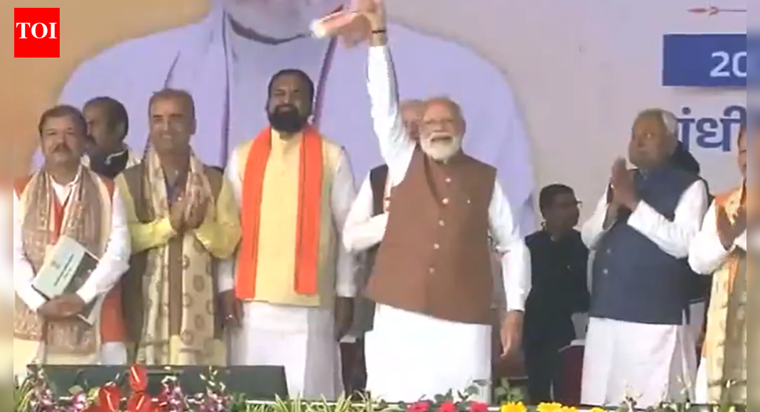 Prime Minister Narendra Modi was seen waving his signature gamcha at Nitish Kumar’s swearing-in ceremony in Patna, marking the latter’s record 10th term as Bihar Chief Minister. PM Modi congratulated the new government and thanked the people of Bihar for the NDA’s significant mandate. PM Modi waves ‘gamcha’ again (Image/X@ANI)  NEW DELHI: Prime Minister Narendra Modi drew attention at Patna’s Gandhi Maidan on Thursday as he waved his signature ‘gamcha’ while attending Nitish Kumar’s swearing-in ceremony.The Janata Dal (United) chief took oath as Bihar chief minister for a record 10th time in the presence of senior BJP leaders and several NDA chief ministers.This is not the first time PM Modi has expressed his celebratory gesture with the traditional cloth. Last week, after the NDA’s massive victory in the Bihar Assembly elections, he was seen waving a gamcha with high energy at the BJP headquarters in Delhi.Wearing a Nehru jacket and standing alongside Nitish Kumar, BJP ministers Samrat Chaudhary and Vijay Kumar Sinha and Bihar Governor Arif Mohammad Khan, the Prime Minister congratulated the new government. He also thanked the people of Bihar for the 202-seat mandate that brought the NDA back to power in the 243-member assembly.On X, PM Modi extended wishes to Nitish Kumar and his Council of Ministers.“Congratulations to Shri Nitish Kumar Ji on taking oath as Bihar’s Chief Minister. He is an experienced administrator with a proven track record of good governance for many years. My best wishes to him for his tenure ahead,” he wrote.In another post, he said, “My best wishes to all those who have taken oath as Ministers in the Bihar Government. This is a wonderful team, with dedicated leaders who will take Bihar to new heights. Wishing them the very best.”He also congratulated Samrat Chaudhary and Vijay Kumar Sinha and praised their grassroots work and role in public service.About the AuthorTOI News DeskThe TOI News Desk comprises a dedicated and tireless team of journalists who operate around the clock to deliver the most current and comprehensive news and updates to the readers of The Times of India worldwide. With an unwavering commitment to excellence in journalism, our team is at the forefront of gathering, verifying, and presenting breaking news, in-depth analysis, and insightful reports on a wide range of topics. The TOI News Desk is your trusted source for staying informed and connected to the ever-evolving global landscape, ensuring that our readers are equipped with the latest developments that matter most.”Read MoreEnd of ArticleFollow Us On Social MediaVideosMarking a Political Milestone, Nitish Kumar Sworn In as Bihar CM for the 10th TimeIndian Navy Sends Strong Signal To Beijing As China Offers Submarines to Pakistan, Assures ReadinessUS Approves Major Arms Deal For India With Javelins And Excalibur To Counter Regional Threats”We Are Done…” Trump Recalls Critical Modi Call That Averted India-Pakistan Nuclear ClashNitish Kumar To Take CM Oath For Record 10th Time At Patna’s Gandhi Maidan, PM Modi To AttendBangladesh To Seek Interpol’s Help To Extradite Sheikh Hasina From India’Fatwa Issued…’: BJP Jabs ‘Indira Nazi Congress’ For Criticising Tharoor Over Modi Speech PraiseRussia Showcases Missile-Only Pantsir SMD-E Air Defence System At Dubai Airshow 2025’We Hit India…’: Pakistani Leader’s Explosive Admission Unmasks Islamabad’s Terror Links Again’Can’t Rule Out All-Out War’: Pakistan’s Khawaja Asif Rattled Over Army Chief’s Sindoor 2.0 Warning123Photostories8 animals that look earless but hear through hidden adaptations8 easy exercises for kids to do at homeCristiano Ronaldo’s partner Georgina Rodríguez is a true fitness role model: Want her glow? Try these 5 fitness moves6 Indian dishes among the 100 Best Chicken Dishes in the WorldSonam Kapoor dresses like late Princess Diana to announce second pregnancy7 emotional wounds of childhood parents may fail to recognizeBoiled Black Chana Soup with pepper: 5 ways it can upgrade health and nutritionHow Narela could become Delhi’s new education hub as DDA launches massive project5 things moms should learn from Stranger Things’ Joyce Byers5 things not to tell your teenager when they share about their first love123Hot PicksDelhi AQI TodayBihar Minister List 2025Bihar CM Oath CeremonyGold rate todaySilver rate todayPublic Holidays NovemberBank Holidays NovemberTop TrendingTrevon DiggsTom BradyMLB SignsDraymond GreenCanara Bank Manager RobberyFortnite DownTop Stock RecommendationsGold Silver Price PredictionStefon DiggsBaker Mayfield Wife