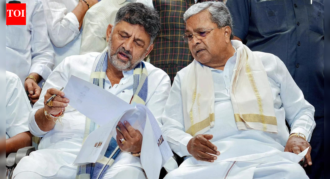 NEW DELHI: Will the Congress replace Siddaramaiah with D K Shivakumar as the chief minister of Karnataka? Had the top Congress leadership agreed to a power-sharing formula in 2023 to broker truce between two of its tallest leaders in the state – both vying for the top post? While the Congress has refused to clear the air on these questions, the supporters of the two heavyweights have on several occassions made contrary claims in the open much to the embarrassment of the party leadership. Little wonder then on November 20, when Siddaramaiah completed two and a half years as the chief minister, reports quoting Congress sources suggested that at least 15 MLAs and about a dozen MLCs have camped in Delhi to push the party leadership to make Shivakumar the next chief minister. Ironically, Karnataka, which gave the Congress one of its biggest electoral victories in recent times when in 2023 the grand-old party stormed to power with 135 seats in the 224-member state assembly, has also been one of its biggest worries since then.With the Congress leadership dithering – the internal ‘nataka’ in the state is out in the open like never before forcing the party to issue a stern warning to its MLAs and leaders against making any public statements on the issue of leadership.This even as Siddaramaiah has been quick to interpret the leadership’s silence as a tacit approval for his stand on the issue. “Has the high command spoken on it? We can’t help it. Earlier also some people were discussing it, and now they might have gone (to Delhi). Finally, Shivakumar and I have to listen to whatever the high command says,” the chief minister said when asked about some MLAs and MLCs camping in Delhi. To a question whether he would present the next two state budgets, Siddaramaiah retorted, “Why are you asking this? Yes, I will continue. I will present the budgets in future also.”Clearly, the chief minister seems to be in no mood to step down. This should worry the Congress as DK Shivakumar, while not raising the pitch himself, has backed the action of his supporters. “All MLAs have the right to visit and meet their leaders. You cannot stop them. You cannot tell them not to go. Many MLAs travel with ministers, and many go with the chief minister. Who has stopped them? No one has troubled them,” the deputy chief minister said defending the leaders who reportedly went to Delhi in his support.DK Shivakumar, who is also the state Congress president, has made it clear that he expects the party high command to do the needfull. Refusing to join issues with Siddaramaiah, DKS has shifted the onus to party’s leadership. “Our CM has always articulated his ideology. I will not comment on it. He has said the matter is between him and the high command. Siddaramaiah has stated that he will abide by whatever the high command decides. The CM will listen to the high command, and I am also on the same page. We are all committed to the high command’s decision,” DKS said when asked about Siddaramaiah’s claim of completing his full tenure of five years. “Honourable CM Siddaramaiah has stated that he will complete five years. I wish him all the luck,” DKS added in a cryptic response.Interestingly, Randeep Singh Surjewala, the AICC general secretary in-charge of Karnataka, tried to put the blame for leadership tussle on a “decisively defeated and faction-ridden” BJP, along with a section of the media. “Had a discussion with Karnataka CM and Deputy CM and they agreed that a decisively defeated and faction ridden Karnataka BJP, along with a section of the media, are designedly running a maligning campaign against Karnataka and its Congress government,” he alleged in a post on ‘X’. Surjewala and the Congress would do well to accept that it is their leaders and MLAs who are speaking in public leading to speculations.The Congress leadership needs to act before it is too late. Both Siddaramaiah and DKS enjoy considerable support in the state perhaps making it difficult for the Congress leadership to take a decision. However, the delay and dithering could prove costly to the grand-old party, which has its own government in only 3 states – Karnataka, Andhra Pradesh and Himachal.The Congress leadership would do well to remember Rajasthan where leadership tussle between two state heavyweights cost its government and the party almost lost Sachin Pilot. If the Congress continues to dither in Karnataka as it did in Rajasthan, the grand-old party may end up losing another state and that too much before the next assembly elections – which are due in 2028.About the AuthorTOI News DeskThe TOI News Desk comprises a dedicated and tireless team of journalists who operate around the clock to deliver the most current and comprehensive news and updates to the readers of The Times of India worldwide. With an unwavering commitment to excellence in journalism, our team is at the forefront of gathering, verifying, and presenting breaking news, in-depth analysis, and insightful reports on a wide range of topics. The TOI News Desk is your trusted source for staying informed and connected to the ever-evolving global landscape, ensuring that our readers are equipped with the latest developments that matter most.”Read MoreEnd of ArticleFollow Us On Social MediaVideosAmit Shah Says BSF Crushed 118 Pak Posts, He Issues Tough Security Message From Sindoor Van In KutchEx-CIA Reveals Savage Reply To Imran Khan’s PTI After Apology Demand Over His India-Pak War Analysis’All 140 MLAs Are Mine’: DK Shivakumar Amid Karnataka CM Speculation; Siddaramaiah RespondsKabul Turns To India As New Trade Partner Amid Pak Blockades And Push For Fresh Regional CorridorsTejas Crashes In Dubai Air Show Display As Massive Fireball Sparks Panic, Pilot Succumbs To InjuriesDeadly 5.5 Earthquake Rocks Bangladesh, Killing At Least Six, Triggers Widespread Panic Across DhakaIndia Demands End To Veto Manipulation And Calls For Comprehensive Reform Of The UN Security CouncilOperation Sindoor 2.0 Talk Rises As Expert Says India Must Hit Pak But Fix White Collar Terror TooIn Fiery UK Conclave Speech, Suhel Seth Says India Has Evolved Beyond 1947, Now Shapes Global PowerShashi Tharoor Says The UN Cannot Be Abandoned Despite Gaza And Ukraine At Desmond Tutu Lecture123PhotostoriesHow to make Zero-Oil Soya Biryani at homeFrom FOMO to Slaps: New age Gen Z terms parents should know7 Ocean-inspired baby names that sound calm and sereneBaby girl names inspired by Bible characters perfect for gen alpha babiesWorld Television Day: 10 remarkable facts about theidiotbox5 high-fiber foods to combine with broccoli and easy dishes10 effective ways to keep pollution out of your home!From ‘120 Bahadur’ to ‘The Family Man 3’: Movies and OTT releases to watch this weekendHow Bollywood mothers turned tender love into unshakeable strength on screenMumbai Infrastructure Boost: LBS Marg-BKC Flyover Connector Nears Early Completion, Promises Seamless Traffic Flow123Hot PicksDelhi AQI TodayBihar Minister List 2025Bihar CM Oath CeremonyGold rate todaySilver rate todayPublic Holidays NovemberBank Holidays NovemberTop TrendingBest Rockstar Games to Play for GTA 6Savannah JamesWayne GretzkysTrevon DiggsDelhi School Suicide CaseKolkata EarthquakeCandace OwensGavin BrindleySophie CunninghamMLB Trade Rumors