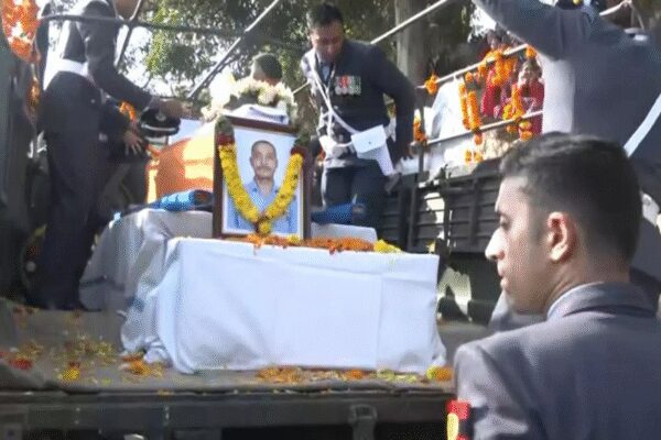 Wing Commander Namansh Syal, a decorated IAF pilot, tragically lost his life in a Tejas jet crash during the Dubai Air Show. His mortal remains were brought to his Himachal Pradesh village for final rites. Syal, a proud son of Kangra, was known for his bravery and dedication. The nation mourns this brave pilot. Mortal remains of Wing Commander Namansh Syal reach his native village in Kangra (ANI image)  NEW DELHI: The mortal remains of Wing Commander Namansh Syal, who lost his life in the Tejas fighter jet crash during the Dubai Air Show 2025, were brought to his native village of Patialkar in Himachal Pradesh’s Kangra district on Sunday.Villagers, family members and officials gathered to pay emotional tributes as his last rites are set to be performed.The Indian Air Force (IAF) confirmed the pilot’s demise after the aircraft crashed and burst into flames during a low-level aerobatic demonstration at Al Maktoum International Airport, Dubai on Friday.Local residents and friends described Syal as a “gem” and the pride of their village and school.Sandeep Kumar, a local, said, “”We are from the same village as Namansh, Patialkar. Everyone in our village is sad. He was like our younger brother. This should not have happened. We do not have words. We met him 3-4 months ago when he visited our village.”Pankaj Chadha, who studied alongside Wing Commander Namansh Syal, recalled their school days and how he was a gem.”I have also studied in the same school as Namansh, Sainik School Sujanpur Tira. We have lost one of our gems. He was the pride of our school. We will go to his native village, Patialkar. He made all of us very proud,” Chadha said.The mortal remains were flown from Dubai to Sulur Air Base in Coimbatore earlier in the day, where Coimbatore District Collector Pavankumar G. Giriyappanavar, Superintendent of Police Dr K Karthikeyan and IAF officials paid floral tributes. The Emirati Defence Forces also accorded Syal a ceremonial guard of honour in recognition of his bravery and service.Who was Wing Commander Namansh Syal?Wing Commander Namansh Syal, 37, hailed from Patialkar village in Nagrota Bagwan tehsil of Kangra district, Himachal Pradesh. He was posted at Sulur Air Force Station in Tamil Nadu and was attached to No 45 Squadron, the “Tejas Daggers” of the IAF.Syal, an experienced fighter pilot, was a graduate of Sainik School Sujanpur Tira, Hamirpur and the National Defence Academy (NDA). He trained with the Hunter Squadron at the Air Force Academy and earned his wings with distinction.Wing Commander Namansh Syal (ANI image) His father, Jagannath Syal, is an ex-armyman who later became a teacher, while his wife, Afsaan, also serves as a Wing Commander at Sulur Air Base. The couple has a seven-year-old daughter.Himachal Pradesh chief minister Sukhvinder Singh Sukhu paid tribute, calling Syal a “courageous, dutiful, and valiant pilot”. He added that “the nation has lost a brave son of Kangra district.”Defence minister Rajnath Singh expressing his grief wrote in a post on X, “Deeply anguished at the loss of a brave and courageous IAF pilot during an aerial display in Dubai Air Show. My heartfelt condolences to the bereaved family. The nation stands firmly with the family in this tragic hour.”Chief of Defence Staff General Anil Chauhan also offered condolences, affirming the armed forces’ solidarity with the family.How the tragic mishap occurred?The Tejas Mark-1 fighter jet was performing an eight-minute aerobatic demonstration when it could not recover from a low-altitude “negative G-turn,” plunging to the ground and erupting into flames in front of a large audience.Visuals from the Dubai Air Show showed the jet crashing and sending thick black smoke into the sky. Emergency teams rushed to the site, but Wing Commander Syal could not eject in time and sustained fatal injuries.This was the second crash involving the lightweight multi-role Tejas since its induction into the IAF a decade ago. The first crash, near Jaisalmer in March last year, saw the pilot safely eject. The IAF has ordered a court of inquiry to ascertain the cause of the crash, coordinating with Dubai aviation authorities and recovering the aircraft’s black box.Veteran pilots highlight that such accidents can occur due to sudden loss of power, control malfunction or spatial disorientation during negative G maneuvers.About the AuthorTOI News DeskThe TOI News Desk comprises a dedicated and tireless team of journalists who operate around the clock to deliver the most current and comprehensive news and updates to the readers of The Times of India worldwide. With an unwavering commitment to excellence in journalism, our team is at the forefront of gathering, verifying, and presenting breaking news, in-depth analysis, and insightful reports on a wide range of topics. The TOI News Desk is your trusted source for staying informed and connected to the ever-evolving global landscape, ensuring that our readers are equipped with the latest developments that matter most.”Read MoreEnd of ArticleFollow Us On Social MediaVideosModi Pitches New Era Of Unified Global Response With Satellite Data And Minerals Initiative”Govt Is Making Sure Muslims Never Raise Their Heads”: Jamiat Chief On Al-Falah ActionIAF Officer Namansh Syal Flown Back to India After Tejas Jet Crash in Dubai Air ShowShah Rukh Khan Pays Tribute To Victims Of Pahalgam And Delhi Blasts at Global Peace Honours 2025Piyush Goyal Completes Three Day Israel Visit Emphasizing Strengthened Ties And Future CooperationTrump Says He Brokered Eight Peace Deals Including India And Pakistan During Mamdani MeetUP Gears Up For Biggest Crackdown Yet As CM Yogi Mandates Detention Hubs For Illegal ImmigrantsModi, Meloni Share Warm Laughter on G20 Sidelines in Johannesburg‘In memory of our brothers’: Russian Pilot’s Heartfelt Note For Indian Tejas Pilot After Dubai Crash’Objective Is To Destroy The Enemy’: Op Sindoor Echoes As Indian Army Vows Stronger Response to Pak123Photostories10 benefits of drinking lemon juice with black salt every morning6 animals that react aggressively to their own reflectionFrom ‘Agneepath’ to ‘Baazigar’: The films that transformed Bollywood’s revenge narrativeBroadway-Poonamallee stretch gets ready for Chennai’s first BRTS corridorHypertension symptoms in kids: Signs parents must watch forSun-soaked November travel: 8 warm getaways to escape the chillNaga Chaitanya birthday special: A look at adorable social media moments with wife Sobhita DhulipalaTrailblazing Bollywood women who changed what it means to be a heroine on screenDelhi to Get 20 New Parking Facilities as MCD Targets Roadside Parking CrisisWalking: 5 reasons why this simple exercise is good for women123Hot PicksDelhi AQI TodayBihar Minister List 2025Bihar CM Oath CeremonyGold rate todaySilver rate todayPublic Holidays NovemberBank Holidays NovemberTop TrendingAuston Matthews InjuryKim KardashianBrittany MahomesTaylor SwiftDelhi School AdmissionsSmriti MandhanaJosh Allen InjuryCharvarius WardFortnite Chapter 7 LeakedCade Cunningham