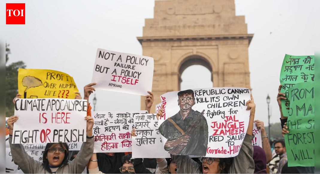 Anti-pollution protests in Delhi turned political as demonstrators displayed pro-Maoist posters, leading to over 22 arrests. Police reported protesters used chilli spray on personnel. The BJP labelled them ‘professional protesters’ and ‘urban Naxals.’ Meanwhile, Aam Aadmi Party questioned the BJP-led Delhi government’s “inaction” on the pollution as the air quality remained “very poor” in the region.  NEW DELHI: Chilli sprays, pro-Maoist posters and over 22 arrests characterised the anti-pollution protests in the national capital region on Sunday. The protests turned political, with the Bharatiya Janata Party leaders bringing the “urban Naxals” narrative to the demonstrations.Meanwhile, Aam Aadmi Party questioned the BJP-led Delhi government’s “inaction” on the pollution as the air quality remained “very poor” in the region.’We Can’t Breathe’: Activists, Parents, Kids Held During Delhi Clean-Air Protest At India GatePeople had also gathered at the same location on November 9, urging the government to enforce measures to reduce air pollution in the NCR.Hidma posters on displayVisuals from the protests showed the demonstrators holding posters of Maoist commander Madvi Hidma, who was recently killed in an encounter.”A protest was held this evening at C Hexagon, India Gate, over pollution. But the protesters were holding posters of Maoist commander Madvi Hidma. When they tried to block the road, the police tried to remove them, but they sprayed pepper spray on the police personnel and tried to attack them. The police are now taking legal action against them,” ANI quoted Delhi Police saying.Hidma, a CPI(M) central committee member and the secretary of the Dandakaranya Special Zonal Committee, was killed on November 18 along with his wife, Rajje, and four other Maoists in the Maredumilli forests of Andhra Pradesh’s Alluri Sitarama Raju district. Security forces had said the group initiated firing during a cordon-and-search operation, sparking an extended encounter.Reacting to this, Chhattisgarh deputy chief minister Vijay Sharma said that the “children had no idea what they were actually talking about.””The children had no idea what they were actually talking about. They mentioned ‘Jantana Sarkar’, but they have neither seen it themselves nor understood its real impact. They are kids; they will understand eventually. Still, they need to learn how democracy functions, how real governments are formed, what their purpose and existence are, and how they actually operate,” he said.Delhi Police narrates what went on groundAccording to the Delhi Police, over 15 protesters were arrested after they allegedly refused to disperse during a demonstration against rising pollution at the C-Hexagon near India Gate. Police said the protesters obstructed official work, blocked the road, and, even more unusually, used chilli spray on police personnel.”Some of the protesters gathered inside the C-Hexagon and then tried to cross the barricade that we had put in place to restrict movement. However, they did not comply; they broke the barricade, came onto the road, and sat there…We requested them to move, as many ambulances and medical personnel were waiting behind them and required emergency access…We removed them from the C-Hexagon to avoid disrupting traffic. During the removal, several protesters scuffled with the police, and many of our personnel were injured,” ANI quoted Devesh Kumar Mahla saying.An FIR was registered, and relevant sections were invoked for assaulting police officers, causing obstruction, and blocking public pathways.BJP calls them ‘professional protesters’BJP leader Shahnawaz Hussain slammed the demonstrators, calling them “professional protesters” for “raising slogans in support of Hidma”.”They came claiming to protest against pollution, but that was not their real purpose. Those with a ‘polluted mind’ began raising slogans in support of Hidma. We have always said that urban Naxals are present in cities as well,” he said.”In the forests, we have eliminated them, and whatever remains will also be finished. ‘Professional protesters’ always look for excuses against the government. Pollution was just a pretext – they aimed to promote Naxalism,” he added.”Under the pretext of pollution, some Naxalite elements staged a protest at India Gate and openly violated every norm of democracy. While protesting, they raised pro-Naxal slogans and sprayed chilli spray directly into the eyes of the police personnel on duty. This clearly shows it was a pre-planned conspiracy in which they failed. Such acts can never be accepted in a democracy,” said BJP MP Praveen Khandelwal.AAP leader Priyanka Kakkar, however, questioned the Delhi government, demanding “emergency meeting” to address the issue of pollution.”This is a national health emergency… The central government should act like a responsible government. It’s been 10 months since they’ve been in Delhi. Have you heard a single step they’ve taken regarding pollution? Nothing at all,” she said.”They should call a meeting with all the Chief Ministers and the Environment Ministers of the NCR, hold an emergency meeting, lay out certain plans, and take certain steps… This government is committing fraud with people’s health. That is why you are seeing citizens protesting again and again in Delhi: they, too, have understood the fraud of this government,” she added.About the AuthorTOI News DeskThe TOI News Desk comprises a dedicated and tireless team of journalists who operate around the clock to deliver the most current and comprehensive news and updates to the readers of The Times of India worldwide. With an unwavering commitment to excellence in journalism, our team is at the forefront of gathering, verifying, and presenting breaking news, in-depth analysis, and insightful reports on a wide range of topics. The TOI News Desk is your trusted source for staying informed and connected to the ever-evolving global landscape, ensuring that our readers are equipped with the latest developments that matter most.”Read MoreEnd of ArticleFollow Us On Social MediaVideosSuicide Bombers Storm Pakistan’s FC Headquarters In Peshawar As Explosions Rock High-Security ZoneJustice Surya Kant, Known For Article 370 Ruling And Pegasus Scrutiny, Takes Oath As India’s New CJI’We May Have Run Away!’: Cyril Ramaphosa’s Joke To PM Modi on Hosting G20 Summit Sparks LaughterHow AQ Khan Became ‘Merchant Of Death’ And Triggered Musharraf’s Outrage, Reveals Ex CIA OperativeIndia, Canada Restart Trade Talks, Aim For -Bn Trade By 2030 As Pm Modi Meets Mark CarneyIndia, Italy Launch Joint Initiative To Counter Terror Financing As PM Modi Meets MeloniPiyush Goyal Meets PM Netanyahu, President Herzog As India-Israel FTA Talks Gain Momentum‘Sindh May Return To India Again’: Rajnath Singh’s Big Remark On India-Pakistan Border’No Longer Optional’: PM Modi Calls For UNSC Reforms At IBSA Meet; Urges United Stand Against Terror‘Extensive Misinformation’: French Navy Slams Pakistan Media Report Over Op Sindoor Claims123PhotostoriesKyunki Saas Bhi Kabhi Bahu Thi fame Sandeep Baswana and Ashlesha Sawant marry after 23 years of living together; share dreamy wedding photosOnce Akshay Kumar, late Irrfan Khan, Manoj Bajpayee’s co-star, THIS actor lost everything and was forced to work as a watchmanKalyani Priyadarshan: Best fashionable moments7 interesting ways to ensure your kids eat eggsAishwarya Rai Bachchan’s approach to raising a confident daughterRoyal babies of 2025: A look at the famous Royal kidsTeaching kids: Who is a stranger? Understanding safe vs. unsafe peopleTop 7 baby names inspired by Lord ShivaHow to make Indian-style kimchi at home for a probiotic boost5 common mistakes people make on the first date123Hot PicksDelhi AQI TodayNew Labour CodeChennai rainGold rate todaySilver rate todayPublic Holidays NovemberBank Holidays NovemberTop TrendingChip KellyAuston Matthews InjuryCola Social Security PaymentsBrittany MahomesCanada Citizenship ActMichael IrvinSmriti MandhanaJosh Allen InjuryTejas CrashFortnite Chapter 7 Leaked