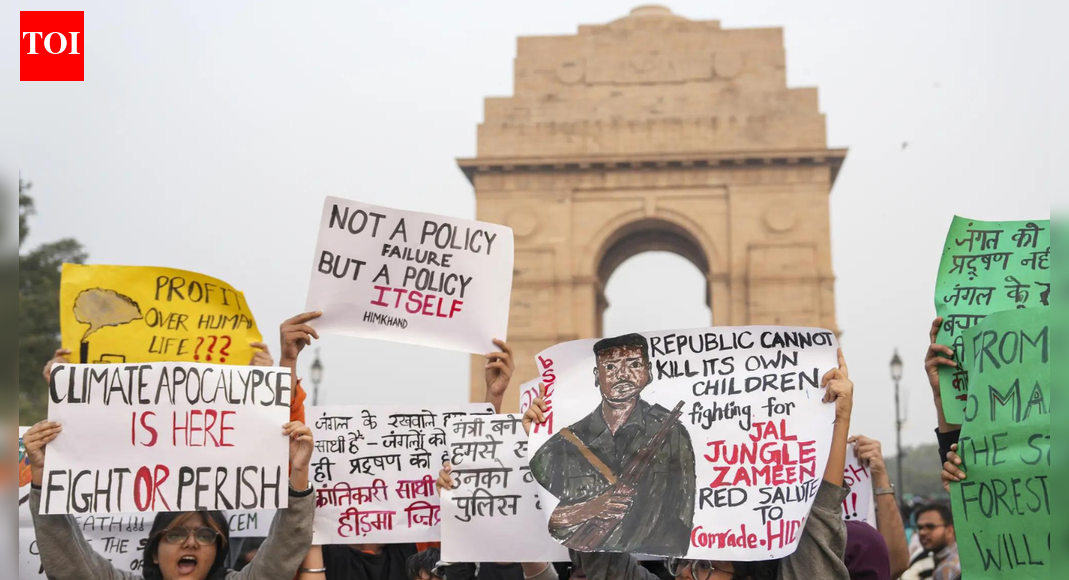 BJP leader Sudhanshu Trivedi criticized protesters at India Gate for raising slogans supporting a slain Naxal commander, accusing them of being influenced by “pollution of Marx and Mao.” The protest, initially against air pollution, saw demonstrators holding posters of Madvi Hidma, leading to arrests by Delhi Police for obstructing personnel and assaulting them.  NEW DELHI: Bharatiya Janata Party on Monday said that the “pollution of Marx and Mao” is denser in the brains of the agitators after slogans condemning Naxal commander Hidma’s encounter were raised during a protest over rising air pollution levels in Delhi.During a press conference, BJP leader Sudhanshu Trivedi said that the “real face” of protestors was out soon as they started raising slogans in support of a slain Naxal commander.”Some people reached India Gate with a mask on their faces that they are there to protest against the pollution. The masks were off as soon as they reached there, and the real face was out, and they started raising slogans in support of a slain Naxal commander,” the BJP leader said.He also latched on the incident to target Congress and claimed that the party “dreams” of coming to power with the support of the extremists.”The PM has said that the Congress has become the Muslim League-Maoist. More than the air pollution, the pollution of Marx and Mao is denser in their brains. Along with that, they dream of coming to power with the support of extremist ‘Kathmullas’. This is even more dangerous,” Trivedi said.This comes after visuals from the Sunday protest at India Gate showed the demonstrators holding posters of Maoist commander Madvi Hidma, who was recently killed in an encounter.”A protest was held this evening at C Hexagon, India Gate, over pollution. But the protesters were holding posters of Maoist commander Madvi Hidma. When they tried to block the road, the police tried to remove them, but they sprayed pepper spray on the police personnel and tried to attack them. The police are now taking legal action against them,” ANI quoted Delhi Police saying.Hidma, a CPI(M) central committee member and the secretary of the Dandakaranya Special Zonal Committee, was killed on November 18 along with his wife, Rajje, and four other Maoists in the Maredumilli forests of Andhra Pradesh’s Alluri Sitarama Raju district. Security forces had said the group initiated firing during a cordon-and-search operation, sparking an extended encounter.Meanwhile, Delhi Police also arrested 15 activist on charges of obstructing its personnel and assaulting them, besides blocking the road during the protest.Patiala House Court remanded 5 accused in 2 days’ judicial custody. The court has asked the police to file a copy of the videos in the court. Additionally, the court asked to send one accused to a safe house till his age is verified, as he has claimed to be a minor.The situation at the protest escalated as some demonstrators allegedly used pepper spray on police personnel while being removed from the scene, the official said.”The situation then turned into a scuffle, and some protesters used pepper spray on our personnel, which is unusual and rare,” the officer said, adding that so far, police have arrested at least 15 protesters.When asked about slogans allegedly raised in support of Maoist leader Madvi Hidma, the officer said they are probing the matter from all angles.The Delhi Coordination Committee for Clean Air, in a statement, said the city’s worsening air quality has become a “serious risk” to public health and alleged that authorities have failed to address the root causes of pollution.It further alleged that air quality has remained in the “severe” category, while the government relies on “cosmetic measures” such as water sprinklers, cloud seeding and spraying near Air Quality Index (AQI) stations instead of finding long-term solutions to tackle the issue.Meanwhile, Scientists for Society (SFS), one of the organisations that participated in Sunday’s “Delhi Against Clean Air” protest here, has distanced itself from certain groups that allegedly raised slogans unrelated to the protest’s central theme of air pollution.In a statement issued on Monday, the SFS said it had joined the protest “solely on the issue of pollution” and emphasised that the primary objective of the demonstration was to highlight Delhi’s severe air quality crisis, educate citizens, and question what they described as the government’s “failure and unwillingness” to act.About the AuthorTOI News DeskThe TOI News Desk comprises a dedicated and tireless team of journalists who operate around the clock to deliver the most current and comprehensive news and updates to the readers of The Times of India worldwide. With an unwavering commitment to excellence in journalism, our team is at the forefront of gathering, verifying, and presenting breaking news, in-depth analysis, and insightful reports on a wide range of topics. The TOI News Desk is your trusted source for staying informed and connected to the ever-evolving global landscape, ensuring that our readers are equipped with the latest developments that matter most.”Read MoreEnd of ArticleFollow Us On Social MediaVideos‘Enemies of the Nation Are Our Enemies’Owaisi Condemns Delhi Blast’Double Trade By 2030′: Piyush Goyal’s Big Remarks As India, Canada Agree To Resume FTA TalksTejas Crash: HAL Issues Clarification As Court Of Inquiry Probes Wing Commander Namansh Syal’s DeathDelhi Air Pollution Protest At India Gate Turns Violent Amid ‘Madvi Hidma Amar Rahe’ SlogansRajnath Singh’s Sindh Comment Sparks Pakistan Fury As Islamabad Labels India ‘Expansionist’ AgainINS Mahe Commissioned As Indian Navy’s New Aatmanirbhar Submarine Killer For Stronger Coastal ShieldSuicide Bombers Storm Pakistan’s FC Headquarters In Peshawar As Explosions Rock High-Security ZoneJustice Surya Kant, Known For Article 370 Ruling And Pegasus Scrutiny, Takes Oath As India’s New CJI’We May Have Run Away!’: Cyril Ramaphosa’s Joke To PM Modi on Hosting G20 Summit Sparks LaughterHow AQ Khan Became ‘Merchant Of Death’ And Triggered Musharraf’s Outrage, Reveals Ex CIA Operative123PhotostoriesFrom Dharmendra to Dev Anand: Veteran style icons who shaped Bollywood’s fashion historyFrom Nushrratt Bharuccha to Tiger Shroff: Bollywood stars stuck in repetitive on-screen images10 most effective natural hacks to permanently get rid of mice and rats at homeDelhi’s bold vision: Luxury metro coaches, tunnels and pod taxisSticking out: 8 animals with incredibly long tonguesAkshay Kumar’s discipline and fitness lessons for childrenSadhguru reveals how many times you must chew each bite for better digestionRemembering Dharmendra: Pall of gloom descends on Mumbai’s Sunny Villa, last rites performed at Vile Parle crematorium; celebrities, fans pay tributesWork picks up on Rs 621 crore Anna Salai flyover in Chennai as spans arrive10 phrases that can calm down an angry child123Hot PicksDelhi AQI TodayNew Labour CodeChennai rainGold rate todaySilver rate todayPublic Holidays NovemberBank Holidays NovemberTop TrendingNew Labour LawsIslam MakhachevCola Social Security PaymentsBrittany MahomesCanada Citizenship ActDelhi ProtestSmriti Mandhana WeddingJack HughesRama Raju MantenaFortnite Chapter 7 Leaked