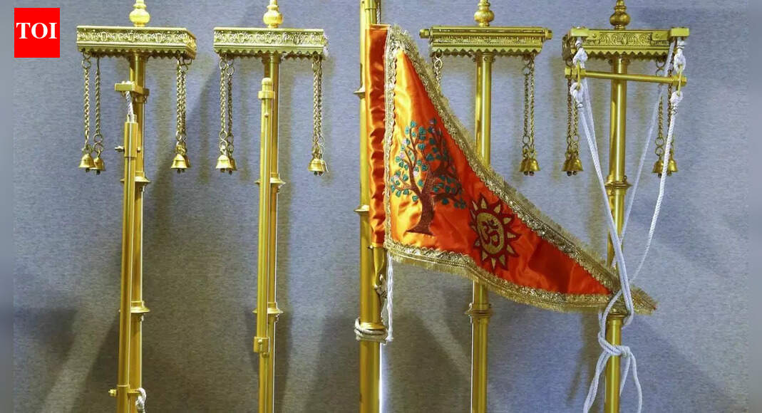 Prime Minister Narendra Modi has arrived in Ayodhya to hoist the specially crafted “Dharma Dhwaj” atop the Shri Ram Janmabhoomi Temple. This significant event, scheduled for Vivah Panchami during the auspicious Abhijit Muhurat, symbolizes the culmination of a centuries-old aspiration and a moment of immense cultural pride. The flag, engineered for durability, bears sacred symbols representing core Sanatan Dharma values. Ayodhya Dharma Dhawaj (PTI photo) NEW DELHI: Prime Minister Narendra Modi reached Ayodhya on Tuesday to hoist the “Dharma Dhwaj” atop the Shri Ram Janmabhoomi Temple, a moment residents describe as the fulfilment of a centuries-old aspiration.The specially designed flag, 22 feet long and 11 feet wide, has been crafted by a parachute specialist from Ahmedabad to withstand high-altitude conditions on the 161-foot temple summit. Weighing between two and three kilograms, the flag has been engineered for durability on the 42-foot flagpole.The ‘Dharma Dhwaj’ carries three sacred symbols, Om, the Sun and the Kovidara tree, each representing core values of Sanatan Dharma. Om signifies the eternal spiritual sound and cosmic vibration. The Sun symbol marks Lord Rama’s Suryavanshi lineage, invoking divine energy. The Kovidara tree, believed to be a hybrid of the Mandar and Parijat created by Rishi Kashyap, symbolises ancient knowledge and the continuity of sacred traditions.The flag is scheduled to be hoisted during the Abhijit Muhurat on Vivah Panchami, considered auspicious in the Ramayana tradition. A four-day ‘havan’ has been under way in the Yagna Mandap ahead of the ceremony, with around 100 priests performing rituals.Ram Janmabhoomi Teerth Kshetra general secretary Champat Rai said thousands of saints from eastern Uttar Pradesh and about 7,000 invitees will attend the ceremony. RSS chief Mohan Bhagwat, Uttar Pradesh hovernor and chief minister Yogi Adityanath are expected to be present. Mobile phones will not be permitted inside the temple premises during the event.Residents said the hoisting of the “Dharma Dhwaj” marks not only the completion of the Ram Temple’s construction but also a moment of cultural pride for followers of Sanatan Dharma around the world.About the AuthorTOI News DeskThe TOI News Desk comprises a dedicated and tireless team of journalists who operate around the clock to deliver the most current and comprehensive news and updates to the readers of The Times of India worldwide. With an unwavering commitment to excellence in journalism, our team is at the forefront of gathering, verifying, and presenting breaking news, in-depth analysis, and insightful reports on a wide range of topics. The TOI News Desk is your trusted source for staying informed and connected to the ever-evolving global landscape, ensuring that our readers are equipped with the latest developments that matter most.”Read MoreEnd of ArticleFollow Us On Social MediaVideosAsh Cloud From Ethiopia Hits India’s Airspace At High Speed, DGCA Issues Urgent Safety AdvisoryNew Tripura BSF IG Intensifies Border Vigilance Amid Bangladesh InstabilitySpectacular Tribute: 350th Martyrdom Day of Guru Tegh Bahadur Marked with Light-&-Sound ShowSecond Day of Guru Tegh Bahadur’s 350th Martyrdom Tribute Marked with Devotion in Punjab“Indian market offers smooth trade opportunities,” says ASSOCHAM Secretary‘Why? Why? Why?’ Mamata Slams EC, Flags ‘Unusual & Alarming’ Moves Ahead of Bengal Polls’Doesn’t Deserve LoP Post’: BJP Slams Rahul Gandhi For Missing CJI Surya Kant’s Oath CeremonyAs Pakistan Halts Afghan Transit, Kabul Boosts India Partnership And Fast-Tracks The Chabahar RouteIndia’s Soft Power Rises As Jaishankar Expands Global Gita Mahotsav, Kurukshetra Festival OutreachPunjab: Anandpur Sahib Hosts 3-Day Tribute on Guru Tegh Bahadur’s 350th Martyrdom Year123PhotostoriesBrain teaser for kids: Can you find 4 hidden faces in this image?10 things every teenage girl needs to know from her parentsMahabharat: Rare, unique and beautiful baby boy names inspired by the Indian epic5 signs your karma is finally clearing and blessings are nearEthiopia volcanic ash: How to explain this to your child (in simple way)7 foods that naturally warm the body7 ways to deal with an avoidant partnerDharmendra’s final curtain: A journey through his rarest unseen memoriesFind your life path number and understand what’s coming next in your lifeTop oncologist shares 5 foods that can help starve cancer and lower risk123Hot PicksDelhi AQI TodayNew Labour CodeCyclone SenyarGold rate todaySilver rate todayPublic Holidays NovemberBank Holidays NovemberTop TrendingTatsuya ImaiBlake LivelyJoe Thornton Net WorthStem OPT ExtensionMLB Trade RumorsTravis TurnerBrad MarchandTyson FuryDrake LondonDenver Nuggets vs Memphis Grizzlies