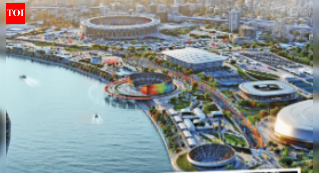 As it gets ready to host the 2030 Commonwealth Games, the city has one eye on the 2036 Olympic Games bid. Fuelling it all are infrastructure projects designed to make it the ‘sports capital’ of India . Confirmation of Ahmedabad as the host city for the 2030 Commonwealth Games (CWG) has sounded the starting gun for an accelerated infrastructure race across the Ahmedabad-Gandhinagar belt. The Commonwealth Sport General Assembly’s approval on Wednesday has pushed the twin cities into delivery mode, with officials stressing that major venue construction plans are locked into a firm timeline.Speaking to the media in Glasgow after Ahmedabad won hosting rights, Gujarat principal secretary (sports, youth and cultural activities) Ashwani Kumar said that the city is poised to be the sports capital of India. “The construction of the Sardar Vallabhbhai Patel Sports Enclave (SVPSE) and the Police Academy Sports Hub will begin in April 2026 and finish by late 2028 or early 2029,” he said..He announced that funding for both these projects had been secured by the govt and that “most venues for the 2030 Games are ready”. He also said that the “organising committee will be constituted within a month”.Long-term visionMuch of the Games’ footprint will be centred on the SVPSE — a purpose-built zone that will anchor Gujarat’s longterm sporting ecosystem. The enclave will house an arena, aquatic centre, tennis courts, training zones, and athlete villages. The Karai Police Academy complex will host athletics, shooting and other disciplines. For Gujarat, the CWG is as much about global visibility as about creating infrastructural and sporting capacity that endures beyond 2030..Unlike some sporting meets that span multiple states, the 2030 Games will be strikingly compact, concentrated almost entirely within the Ahmedabad-Gandhinagar cluster. That will enable faster movement and a lower carbon footprint. “This compactness cuts athlete travel time and allows seamless integration of metro, BRTS and electric mobility,” states the document, ‘Games Vision, Concept and Legacy — Commonwealth Games 2030’, presented before the CWG committee. Only two disciplines — cycling at the Statue of Unity (near Kevadia) and women’s cricket in Vadodara — will take place outside this hub.The Narendra Modi Stadium, the world’s largest cricket stadium, will host the opening and closing ceremonies of the 2030 Games — massive productions that are expected to reflect the Commonwealth Sport values.Beyond the Games, Gujarat — which hosted the National Games in 2022 — is pushing lesser-known disciplines like netball, lawn bowls, kabaddi, and yogasana into the spotlight. The bigger shift is strategic — Ahmedabad and Gandhinagar aim to become year round sports cities, with high performance labs, community spaces and university-linked infrastructure to ensure post Games utilisation..Focus on sustainabilityAhmedabad also plans to discuss sustainability, diversity and inclusion during the Commonwealth heads of govt meeting (CHOGM) 2026 and 2028.Tejas Joshi, president of Credai Gujarat, said, “Hosting the CWG will be a game changer for Ahmedabad. The city’s infrastructure will see a drastic change with improved roads and connectivity. It will create demand for around 20,000 star-category hotel rooms and boost hotel and retail development. It will also eventually bring new migration to the city, resulting in increased housing demand.”Accommodation is expanding fast. “Ahmedabad and Gandhinagar offer 5,420 hotel rooms in the 3-5 star range, with 3,000 more planned, including 1,500 new 5-star rooms. Upgraded university hostels will house athletes during the Games and serve students later,” states the proposal..Sardar Vallabhbhai Patel International (SVPI) airport, handling 13.4 million passengers annually, will add a new terminal by 2026 to double its capacity and introduce e-gates and kiosks.Eye on olympics“World-class sports academies will be set up, encouraging a sports culture among city youths. After the Commonwealth Games, Ahmedabad aims to host the 2036 Olympics. The next decade will bring historic developments to the city,” said Joshi.Behind the scenes, athlete development is accelerating. Gujarat’s sports budget has grown from Rs 2.5 crore to Rs 521 crore over two decades, strengthening long-term athlete development pathways and strengthening academies. Part of the focus is also on scaling up talent hunts like Khel Mahakumbh, which saw engagement from 7 million participants, and schemes such as Shaktidoot to support athletes..Public participation will also be a defining layer. Programmes like Active Gujarat will convert riverfronts and parks into fitness zones. At the same time, Sabarmati Sundays — weekly openstreet events — will be expanded in the run-up to 2030. College students will join as youth ambassadors through the National Service Scheme (NSS) and the National Cadet Corps (NCC). By 2030, Gujarat plans to train 10,000 volunteers and create over 30,000 jobs linked to the Games.About the AuthorKapil DaveKapil Dave is Political Editor at The Times of India, Ahmedabad. He writes on Politics, Governance, Policy Matters and Development. He loves travelling and reading.End of ArticleFollow Us On Social MediaVideosIndia Is a Key Ally, Cyprus Assures Strong Push to Finalise India–EU FTA TalksImran Khan Health Rumour: PTI Holds Sit In Outside Adiala Jail, KP CM Sohail Afridi Stages ProtestRam Madhav Challenges ‘No-Religion’ Narrative in White Collar Terror DebateAustralia Says India Is Now A Leading Global Power, Credits PM Modi For Transforming World DynamicsOusted PM Sheikh Hasina Faces Fresh Conviction as Court Awards 21-Year TermPM Modi Announces Major Move Allowing Private Players Into Nuclear Sector To Spur Advanced ReactorsExplained: Why Vikram-I Could Transform India’s Satellite Launch Market And Global Space Leadership‘Pak, Bangladesh, US…’: BJP Alleges Congress Using Foreign ‘X’ Accounts to Set India’s NarrativePakistan’s Adiala Jail Issues Statement On Imran Khan’s Health Amid Viral Death RumoursThe Indrajaal Ranger: India Unveils AI-Enabled Anti-Drone Patrol Vehicle In Hyderabad123PhotostoriesNature’s Ozempic: 5 edibles that ‘mimic’ the popular weight-loss drug with natural benefits5 knee strengthening exercises you can do at homeThese 4 common habits could be destroying your gut lining5 lethal killer animals that are an example of predators behind beauty5 winter foods that naturally mimic OzempicDid Nike just collaborate with ‘Stranger Things’? Here’s how Indians can grab the collectionWhat is the ideal meal to sleep gap time, and why it is important for digestion and better sleepMalayalam cinema legends who made every frame shine with raw talentBollywood gems reviving forgotten tales with fresh heart and magic for a new generation of cinema lovers everywhereFun facts about the ‘Stranger Things’ cast123Hot PicksDelhi AQI TodayNew Labour CodeWorld NewsGold rate todaySilver rate todayPublic Holidays NovemberBank Holidays NovemberTop TrendingToronto Maple LeafsAyesha CurryFuzzy ZoellerCristiano RonaldoStefon DiggsGabrielle UnionVanessa BryantReed Sheppard GirlfriendStephen CurryCandace Owens
