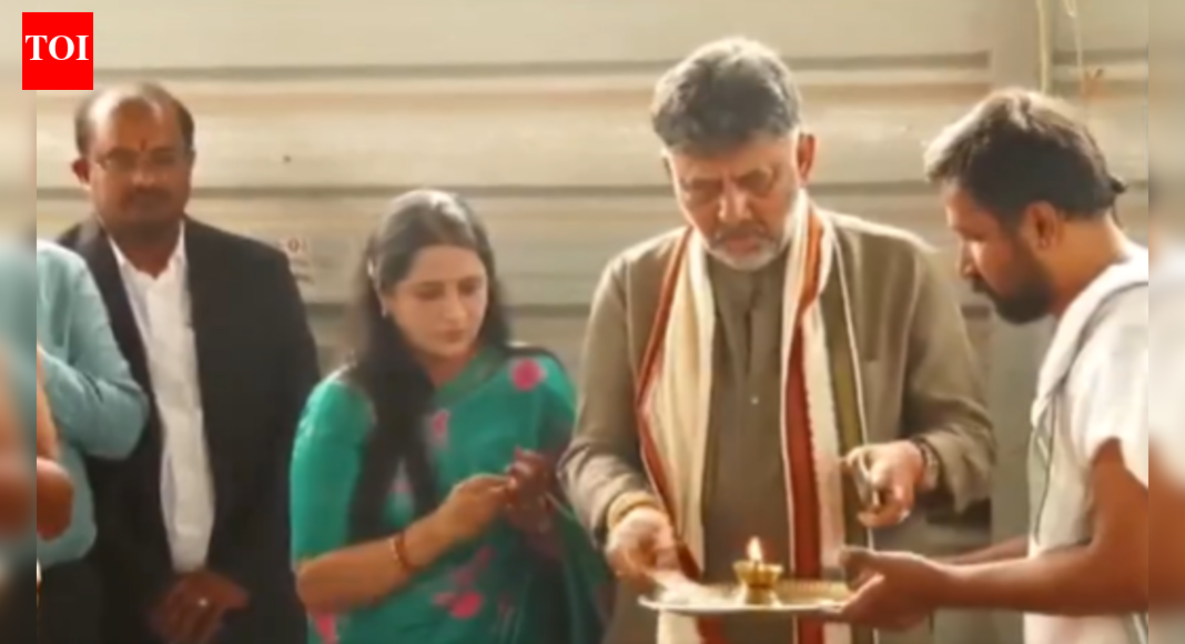 Karnataka Deputy CM DK Shivakumar visited a temple after a breakfast meeting with CM Siddaramaiah amid a power tussle. Shivakumar, who faced legal challenges, expressed a sense of glory at the temple. The meeting followed reports of a power-sharing agreement between the two leaders after the 2023 assembly elections. DK Shivakumar NEW DELHI: Karnataka deputy chief minister DK Shivakumar and his wife Usha Shivakumar offered prayers at Mandya’s Bhoo Varaha Swamy temple on Saturday, just hours after his breakfast meeting with chief minister Siddaramaiah amid a power tussle between the two leaders.“When I was in Tihar Jail, my mother-in-law and father-in-law came to this temple four times,” Shivakumar told reporters, referring to his September 2019 arrest by the Enforcement Directorate in a money-laundering case — which the Supreme Court eventually quashed in March 2024.Siddaramaiah, DK Shivakumar Project Unity After High-Stakes Karnataka Meet Amid Rumours Of Cong RiftThe Congress leader, who also heads the party’s state unit, claimed that a “friend from another party” had been urging him to visit the temple for the past two years.Shivakumar added that the visit was scheduled only this morning.“When I came here, I felt a sense of glory. I asked the priest if I should bring anything, and he said it was enough to come for darshan. I don’t know if he performed a homa (sacred fire ritual) to secure a ‘high position’ for me. All the elders and deities are looking at me with love,” the deputy CM remarked.Earlier, after his breakfast meeting with Siddaramaiah, Shivakumar had described the leadership talks as “productive.”The chief minister had invited his deputy at the behest of the Congress high command.The power tussle between the two dates back to an alleged promise made to Shivakumar after the Congress’ sweeping victory over the BJP in the Karnataka assembly elections in May 2023. The party leadership had chosen the veteran Siddaramaiah as chief minister, appointed Shivakumar his deputy, and reportedly assured a transfer of power after 2.5 years for the remainder of the government’s five-year term.The Siddaramaiah camp — and the chief minister himself — has repeatedly maintained that he will complete his full tenure.About the AuthorTOI News DeskThe TOI News Desk comprises a dedicated and tireless team of journalists who operate around the clock to deliver the most current and comprehensive news and updates to the readers of The Times of India worldwide. With an unwavering commitment to excellence in journalism, our team is at the forefront of gathering, verifying, and presenting breaking news, in-depth analysis, and insightful reports on a wide range of topics. The TOI News Desk is your trusted source for staying informed and connected to the ever-evolving global landscape, ensuring that our readers are equipped with the latest developments that matter most.”Read MoreEnd of ArticleFollow Us On Social MediaVideos“Our Rashtra Built On Culture, Not Clashes”: RSS Chief’s Big Claim On Nationhood“Oppression Will Trigger Jihad”: Jamiat Chief’s Explosive Claim Stirs StormEAM Jaishankar Decodes Massive US China Power Shift And Global Realignment In Sharp Kolkata AddressImran Khan Isolation Sparks Fury As PTI Claims His Photo Could Transform Pak’s Political RealityDelhi Court Extends Anmol Bishnoi’s Custody; NIA Probes Gang-Terror LinksAviation Expert Flags Deadly Risk In A320 Fleet After Critical Control System FailurePakistan Still Licking Op Sindoor Wounds: BSF Warns Next Attack Will Trigger Even Stronger ResponseAfter India’s 8.2% GDP Jump, Piyush Goyal Credits Reforms And Predicts Strong, Sustained ExpansionIMD Issues Red Alert as Cyclone Ditwah Approaches TN; Sri Lanka Deaths Exceed 80Siddaramaiah, DK Shivakumar Project Unity After High-Stakes Karnataka Meet Amid Rumours Of Cong Rift123Photostories5 animals that went extinct in recentyearsKajol to Janhvi Kapoor: Celebrity looks that defined today’s fashion mood board8 air-purifying indoor plants that naturally absorb harmful gasesFrom Dharmendra to Amjad Khan: Remembering the ‘Sholay’ stars who are no longer with usGen Z sensations Aneet Padda & Ahaan Panday serve old-school romance with their viral ‘Saiyaara’ glow-upHyderabad Unveils India’s First Mobile Anti-Drone Vehicle to Boost Security MeasuresIn Pics | Tesla Opens India’s First All-In-One Facility in GurgaonNoida Apple Store Unveiled: India’s Fifth Retail Location with Peacock-Inspired Design at DLF Mall of India7 animals that became space travellers ahead of humansShilpa Shetty yet again serves major fashion goals with her silver saree-jacket combo123Hot PicksDelhi AQI TodayNew Labour CodeWorld NewsGold rate todaySilver rate todayPublic Holidays NovemberBank Holidays NovemberTop TrendingGiannis AntetokounmpoBo BichetteWWE Smackdown HighlightsDonald TrumpPerez HiltonCyclone DitwahR AshwinAyesha CurryFuzzy ZoellerJammie Booker