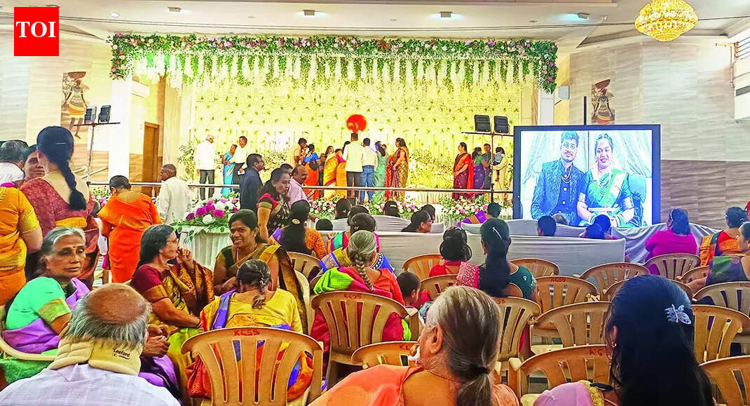 Hubballi/Bhubaneswar: Boarding off, marriage event still on. A software engineer couple who got hitched recently in Bhubaneswar appeared online for their wedding reception in the bride’s Karnataka hometown Hubballi after their IndiGo flight’s last-minute cancellation left them stranded in the Odisha capital.With the reception hall booked in Hubballi, families gathered, and rituals scheduled, the guests took their seats at the venue. The only persons missing were newlyweds Sangam Das and Medha Ksheerasagar.Bengaluru Newlyweds Attend Reception Online After Indigo Cancellations Derail Travel PlansThe couple finally showed up – via video link from Bhubaneswar. They went through the motions on screen in all their wedding finery, completing the event. Medha’s parents sat in the chairs meant for the couple at the venue – a standout moment that stayed with the guests and became another face of the IndiGo fiasco.Bhubaneswar’s Sangam and Medha, who work in Bengaluru, got married on Nov 23 and had a grand reception lined up in Hubballi. The couple had taken tickets from Bhubaneswar to Bengaluru and onward to Hubballi for Dec 2. Tickets for several relatives were also booked for the same day.Then the trouble started. Family members said IndiGo staff kept telling them the flight was “delayed”, beginning 9am on Dec 2 and continuing late into the night. Finally, on the morning of Dec 3 – just hours before the reception – the airline informed the passengers that the flight had been cancelled.With no alternative travel arrangement possible at such short notice, the bride and groom got stuck in Bhubaneswar. “…If IndiGo had informed us earlier, we could have made other arrangements. Because they did not provide timely information, the reception had to be held online,” Medha’s father Anil Kumar told TOI.The couple apologised to the guests with folded hands for not being able to attend the reception in Hubballi in person and thanked them profusely for making the best of the moment despite the disruption.Medha’s father stressed the reception could have proceeded as planned had the airline acted in time. “Because they didn’t provide proper information, we had no option,” Kumar said.End of ArticleFollow Us On Social MediaVideos”Next Year in Russia…” Deputy PM Manturov Urges Indian Companies to Expand Bilateral Trade”Ordinary Indians Pay Price” Rahul Gandhi Calls Indigo Chaos The ‘Cost Of Monopoly Model’India, Russia Renew Call for Inclusive UN Security Council Structure: MEAPutin Says Russia Didn’t Come Only for Energy, Seeks Bold Multifaceted Partnership with IndiaCentre Orders High-Level Probe As IndiGo Flight Operations Set To Normalise In 3 DaysImran Khan Tagged ‘Security Threat’ As Pakistan Army Launches Fiercest Public Attack In Years‘Not Here Only For Energy’: Putin Seeks Broader India-Russia PartnershipPM Modi Urges Putin To Build New Economic Axis As India Becomes Emerging Skilled Capital Of WorldSpiceJet Chairman Ajay Singh Calls IndiGo Crisis ‘Unfortunate’, Offers 100 Extra FlightsPakistan Supports China’s Arunachal Lie As Putin Meets Modi Amid Major India Russia Cooperation123PhotostoriesVijay Deverakonda, Pelli Choopulu and Arjun Reddy; Breakthrough performances that redefined the Telugu lover boyRajesh Khanna-Dimple Kapadia, Saif Ali Khan-Kareena Kapoor Khan; Bollywood marriages spanning age gapsLifestyle expert shares five ‘safe’ ways to drink alcohol if at all one should8 common mistakes people make while making rotis and easy fixes9 fiber-rich dishes made with flattened rice (poha) for breakfastBigg Boss 19: Shehbaz Badesha calls Tanya Mittal fake and irritating; breaks silence on father being trolled for ‘overly friendly’ behaviour with female contestantsAdrian Chiles’ skin cancer diagnosis: How he spotted the symptoms that made all the differenceHow Bhagavad Gita can heal unknown childhood trauma and unlock blockages for success in lifeNutrition fact of the day: Greek yogurt has twice the protein of regular yogurt5 clever animals that deceive predators by playing dead123Hot PicksIndigo Flight DelayPutin India VisitWorld NewsGold rate todaySilver rate todayPublic Holidays NovemberBank Holidays NovemberTop TrendingLos Angeles Lakers vs Boston CelticsNBA trade RumorsOmarion HamptonCandace OwensAryna SabalenkaTrey BensonTravis KelceGeorge PickensStefon DiggsTaylor Swift