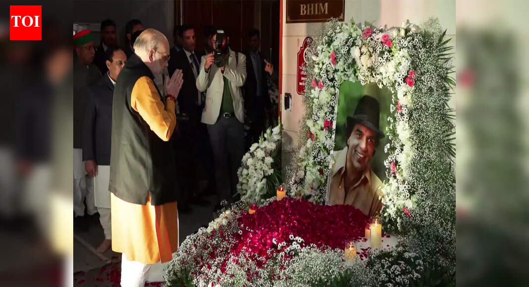 Union Home Minister Amit Shah on Thursday evening attended the prayer meet of late actor Dharmendra at Ambedkar International Centre in Delhi. He also paid floral tribute to the late actor. Amit Shah pays floral tribute to Dharmendra at his prayer meet in Delhi NEW DELHI: Union home minister Amit Shah on Thursday evening attended the prayer meet of late actor Dharmendra at Ambedkar International Centre in Delhi. He also paid floral tribute to the late actor.BJP chief JP Nadda, Union finance minister Nirmala Sitharaman, Delhi chief minister Rekha Gupta, BJP MP Anurag Thakur, Union minority affairs minister Kiren Rijiju, and Union railway minister Ashwini Vaishnaw were also present at the prayer meet. They also met with Dharmendra’s wife and politician, Hema Malini, and paid their condolences. Dharmendra’s passing marked the end of an era in Hindi cinema. Over the decades, he earned admiration for his versatility across genres and became one of the industry’s most loved stars.One of the most iconic actors of his time, Dharmendra, who left for his heavenly abode on November 24, made his mark in Hindi cinema with memorable performances in films like ‘Aya Sawan Jhoom Ke’, ‘Sholay,’ ‘Chupke Chupke’, ‘Ayee Milan Ki Bela’, and ‘Anupama’, among others.Prime Minister Narendra Modi, was among those who paid tribute to Dharmendra after it was announced he had died at home in Mumbai on November 24.PM Modi said that his death marked the end of an era in Indian cinema. “He was an iconic film personality, a phenomenal actor who brought charm and depth to every role he played. The manner in which he played diverse roles struck a chord with countless people,” he wrote on X.Superstar Rajinikanth gave “farewell” to his late “friend” with a heartfelt post, “Farewell, my friend. I will always remember your golden heart and the moments we shared. Rest in peace, Dharam ji. My deepest condolences to his family.”The veteran star also worked in films such as ‘Kaise Kahoon Ke… Pyaar Hai’ (2003) and ‘Kis Kis Ki Kismat’ (2004), both of which were box office failures.After this, he took a brief hiatus and returned with three films in 2007. These were – Anurag Basu’s drama film ‘Life in a… Metro’, Anil Sharma’s sports drama ‘Apne’ and Sriram Raghavan’s neo-noir thriller ‘Johnny Gaddaar’. Both ‘Life in a… Metro’ and ‘Apne’ proved to be critical and commercial successes.In 2023, he surprised everyone with his stellar performance in Karan Johar’s directorial ‘Rocky Aur RKii Prem Kahaani’. With his role, he literally proved that age is just a number.A much-discussed highlight from the film was his kiss with co-star Shabana Azmi, a moment that many hailed as a tender, progressive portrayal of love in later years, and one that took audiences pleasantly by surprise.Even Dharmendra acknowledged the much-hyped scene. In a previous interview with ANI, the veteran star humorously recalled a conversation he had with co-star Ranveer Singh, saying, “Maine Ranveer ko bola, Ranveer, Rocky aur Rani ki prem kahani me, tune to bohot kisses ki hain, or meri ek hi kiss ne hila dala logo ko.”Dharmendra’s footprint stretches beyond the silver screen. He was a Member of Parliament from Bikaner (2004-2009), a judge on the reality show “India’s Got Talent” (2011), and has appeared in historical series ‘Taj: Divided by Blood’.He was also seen in Shahid Kapoor and Kriti Sanon’s romantic comedy ‘Teri Baaton Mein Aisa Uljha Jiya’, which reminded a new generation of his effortless charm. His last film ‘Ikkis’ is set to be released on December 25. End of ArticleFollow Us On Social MediaVideos22 Feared Dead As Truck Falls Into Gorge In Arunachal Pradesh’Warm And Engaging’: PM Modi Holds Phone Call With Trump Amid Trade Talks, US-India Ties Discussed’If They’re Happy, They Should Sign’: Goyal Responds To USTR’s ‘Best Offer Ever From India’ RemarkHow Bangladesh’s Feb 12 Vote Could Reshape India’s Northeast Access And Regional Power BalanceBJP Charges TMC MP of Smoking Inside Parliament After Giriraj-Sougata Face-off Over E-CigaretteExplained: Did Mexico Follow Trump’s Footsteps To Slap Tariff on India? Impact on Indian TradersKharge Hits Back As JP Nadda Slams Nehru, Congress Over Vande Mataram In Rajya SabhaSouth Asian Bloc Minus India? Why Pak’s Fresh Regional Pitch Fails On Economics, Politics, Geography‘Hands Were Trembling’: Rahul Gandhi Takes Sharp Dig At Amit Shah Over Ls AddressTrump’s  Million Gold Card Explained: What America’s Costliest Visa Means For Indian Applicants123Photostories5 love quotes by Ravinder Singh in their most raw and beautiful wordsUltimate caregivers: 5 animals that die after giving birth to their youngSHE Travels: 7 road trips in India every woman who loves driving should experience onceNick Jonas’ journey with type 1 diabetes for two decades: Early signs to spot the diseaseShe entered Bollywood with fame in her blood and success at her feet, then one scandal altered her path foreverSuffering from high uric acid? Try this 6 foods from your kitchen counter as recommended by Ayurveda5 fashion brands owned by royal Indian families you probably didn’t know aboutNot losing weight despite working out? 4 factors might be affecting your metabolism10 quick Korean phrases you can learn before you land in KoreaAre Khalid Al Ameri and Sunainaa Yella getting married? Inside the love story Instagram tried to soft-launch123Hot PicksUS Pakistan DealTrump Gold CardSpiceJet FlightGold rate todaySilver rate todayPublic Holidays NovemberBank Holidays NovemberTop TrendingSherrone MooreIsaiah RiderStephen CurryAdrian MorejonLebron JamesOlivia DunneTroy AikmanBengaluru CrimePaige Shiver Net WorthGabrielle Union