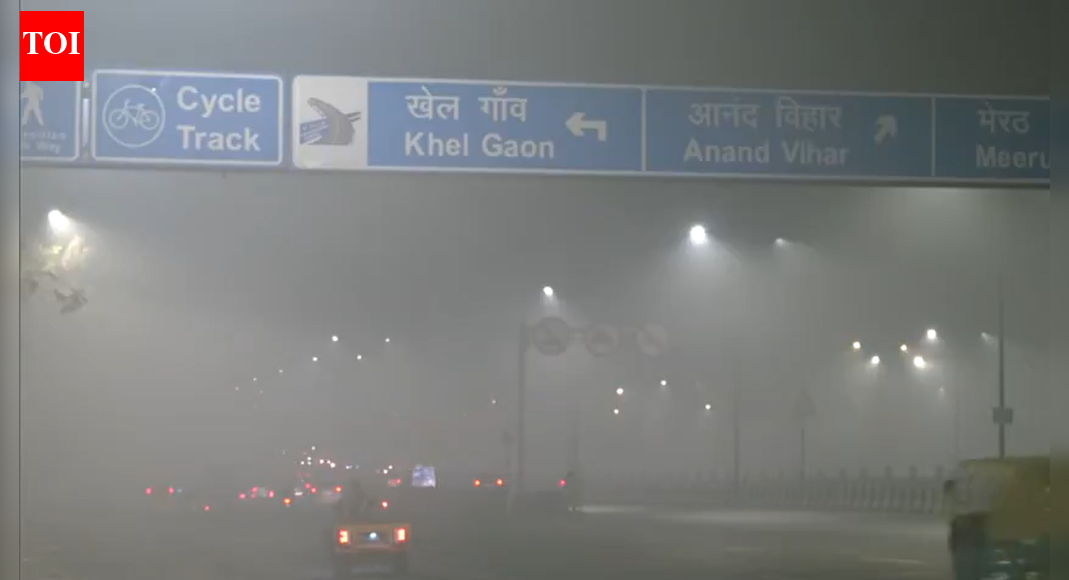 Delhi-NCR faces emergency curbs as air quality plummets to ‘Severe+’ levels, triggering Stage IV of the Graded Response Action Plan. Authorities have enforced strict restrictions across the region due to pollution crossing critical thresholds. This comes after the city’s Air Quality Index surged overnight, leading to dense smog and reduced visibility, impacting public health.  NEW DELHI: With air quality worsening sharply across the Delhi-NCR, authorities on Saturday invoked the strictest restrictions under Stage IV of the Graded Response Action Plan, triggering emergency curbs across the region. This comes hours after implementation of GRAP stage III measured in the national capital region. The Commission for Air Quality Management said its GRAP sub-committee had decided to enforce all measures under Stage IV or ‘Severe+’ air quality with immediate effect after pollution levels crossed critical thresholds. In an official statement, the panel said, “Keeping in view the prevailing trend of air quality and in an effort to prevent further deterioration of air quality in the region, the CAQM Sub-Committee on GRAP decides to invoke all actions as envisaged under Stage-IV of the extant GRAP ‘Severe+’ Air Quality (DELHI AQI > 450), with immediate effect, in the entire NCR.” It added that these steps would be in addition to restrictions already in force under Stages I, II and III.In an official order, the government directed that all administrative secretaries and heads of departments shall attend office regularly, with no more than 50 per cent staff strength physically present.”The remaining 50 per cent staff shall work from home, provided that the Administrative Secretaries and Heads of Departments can call officers/officials to the office, as required to ensure uninterrupted delivery of essential and emergency public services,” the order read.Likewise, the order stipulated that all private offices operating within Delhi shall function with no more than 50 per cent staff physically attending the workplace.”The remaining staff shall mandatorily work from home,” it added. The order also urged all private entities to implement staggered working hours where feasible. Furthermore, private offices have been instructed to ensure strict compliance with work-from-home norms and minimise vehicular movement related to office commutes.”Hospitals and other public/private health establishments, Fire Services, Prisons, Public Transport, Electricity, Water, Sanitation and related municipal services, disaster management and related services, forest and environment departments/agencies engaged in air pollution control, monitoring, and enforcement activities (like teams deployed to curb biomass burning, dust control, GRAP measures, etc.), and other essential/emergency services shall be exempted from these directions,” the order said. Rahul Gandhi Demands Unified National Response As Parliament Debates India’s Air Pollution Crisis The decision came hours after Delhi slipped back into the ‘severe’ category, prompting the reimposition of Stage III curbs earlier in the day. According to official data, the city’s Air Quality Index, which stood at 349 on Friday evening, surged overnight and was recorded at 401 by Saturday morning due to slow wind speeds, a stable atmosphere and unfavourable meteorological conditions that hampered the dispersion of pollutants.According to news agency ANI, As of 7.00 PM, AQI readings were 488 in Anand Vihar, 434 in Ashok Vihar, 496 in Bawana, 457 in Burari, 479 in Chandini Chowk, 394 in IGI Airport, and 445 in Okhla Phase-2.Also read: Delhi AQI turns ‘severe’: GRAP Stage III reimposed across NCR; what’s allowed & what’s notA dense layer of smog enveloped the capital on Saturday morning, reducing visibility and intensifying health concerns. Wazirpur recorded the worst air quality with an AQI of 445, followed by Vivek Vihar at 444, Jahangirpuri at 442 and Anand Vihar at 439. Several other areas, including Rohini, Ashok Vihar, Narela, Mundka and Bawana, also remained in the ‘severe’ range.Poor air quality conditions extended beyond Delhi, with parts of Uttar Pradesh also reporting dense smog. Noida sectors recorded AQI levels of 448, while visibility dropped in cities such as Bulandshahr, Ayodhya and Mainpuri amid fog and haze.Under CPCB norms, an AQI between 401 and 500 is classified as ‘severe’ and poses serious health risks, particularly for children, the elderly and those with respiratory ailments. Authorities have directed enforcement agencies to intensify checks and ensure strict compliance with GRAP measures to prevent further deterioration in air quality.What is NOT allowed under GRAP 4Construction and industrial activity  All construction and demolition activities, including earthwork, excavation, piling and structural work  Operation of stone crushers, brick kilns, hot mix plants and mining activities  Industries using coal, furnace oil or other unapproved fuels Vehicles and transport  Entry of all diesel-powered medium and heavy goods vehicles into Delhi, except those carrying essential goods  Operation of BS-III petrol and BS-IV diesel four-wheelers  Non-essential inter-state diesel buses that are not BS-VI, electric or CNG Other restrictions  Use of diesel generator sets, except for emergency and essential services  Open burning of any kind, including waste and biomass  Any activity that may increase dust or emissionsWhat is allowed under GRAP 4 Essential services and infrastructure  Construction related to essential services such as metro, railways, airports, highways, defence, healthcare and sanitation  Emergency repair and maintenance works with strict dust control measures Transport and mobility  Electric vehicles, CNG vehicles and BS-VI compliant vehicles  Public transport services, including buses and metro  Vehicles used by persons with disabilities Education and offices  Schools may shift to online or hybrid classes, especially for younger students  Offices may reduce staff strength and encourage work from home Utilities and emergency operations  Power generation units supplying electricity  Use of diesel generators for hospitals, data centres, telecom services and emergency situationsAbout the AuthorTOI News DeskThe TOI News Desk comprises a dedicated and tireless team of journalists who operate around the clock to deliver the most current and comprehensive news and updates to the readers of The Times of India worldwide. With an unwavering commitment to excellence in journalism, our team is at the forefront of gathering, verifying, and presenting breaking news, in-depth analysis, and insightful reports on a wide range of topics. The TOI News Desk is your trusted source for staying informed and connected to the ever-evolving global landscape, ensuring that our readers are equipped with the latest developments that matter most.”Read MoreEnd of ArticleFollow Us On Social MediaVideosCongress Questions BJP’s Renaming Of MGNREGA, Hits Out At Gandhi HatredMessi Event Chaos In Kolkata Triggers BJP Attack On Mamata Over Law Order And MismanagementMessi Event Chaos In Kolkata: Bengal Police Detain Organiser, Refunds Announced‘Namaste Trump’ Era Is Over As India–US Relations Turn Fragile Over Tariffs, Says Jairam RameshHouse Democrats Push To Scrap Donald Trump’s India Tariffs As Congress Challenges Emergency PowersMessi’s Kolkata Visit Turns Chaotic As Angry Fans Vandalise Banners At Salt Lake Stadium’PM Not Always Wrong’: Ex-Congress Leader Ashwani Kumar, Calls Party Revival A National ObligationAction Over Rhetoric: CDS Anil Chauhan Sends A Calm But Clear Signal To Pakistan Amid Op SindoorWhen Optics Fail: Top Five Global Moments That Turned Pakistan PM Shehbaz Sharif Into A Meme’No Free Lift For India’: PM Modi’s Chief Economic Adviser Says China Won’t Repeat West’s Mistake123PhotostoriesKohinoor and 5 other legendary diamonds every diamond lover should know aboutLow on Energy? Read This According To Your Birth Date5 everyday habits that unknowingly attract rhodents, insects, lizards into your homeThis actress went from TV star to OTT sensation, has a history with Karan Kundrra, and is now linked to a popular cricket commentatorVadodara-Mumbai Expressway Expansion: Rs 100 Crore Construction of 14km Morbe-Kalamboli Road Begins to Ease Traffic and Freight5 reasons why ‘Made-in-India’ sneakers are having a momentWhat your dad secretly taught you about lifeYour hidden spiritual gift revealed… based on your date of birthLonger locals, more relief: Western Railway begins work to extend 15-car locals up to Bandra7 Brilliant leftover rice recipes that are a must try123Hot PicksMukesh Ambani vs Gautam AdaniDonald TrumpAnurag ThakurGold rate todaySilver rate todayPublic Holidays NovemberBank Holidays NovemberTop TrendingSherrone MooreKell MooreH1B Fee HikeWho is Mia SoretyWho is Jeff ShiverNick FuentesDaniel JonesMeghan MarkleShehbaz SharifPaige Shiver Net Worth