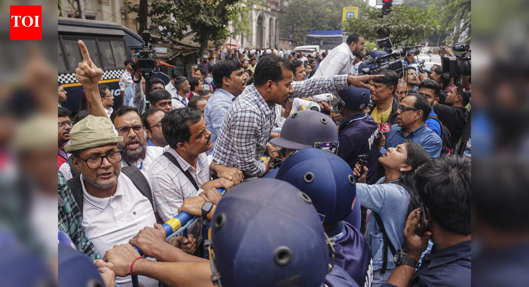 Kolkata: Booth Level Officers (BLOs) under the banner of ‘BLO Adhikar Raksha Committee’ stage a protest over alleged excessive workload during the ongoing Special Intensive Revision (SIR) of electoral rolls, outside Chief Electoral Officer’s (CEO) office, in Kolkata. (PTI Photo) NEW DELHI: Central armed forces will be deployed at the office of the West Bengal chief electoral officer (CEO) in Kolkata and will assume responsibility for its security on Friday, an official said.Also Read: BLOs march to CEO office, protest ‘inhuman’ SIR stressThe Ministry of Home Affairs has approved the Election Commission’s (EC) proposal in this regard, the official added.“Central forces personnel will take charge of security on the second and third floors of the CEO’s office from Friday morning. They will also accompany officials of the CEO’s office when they travel outside the premises in government vehicles,” he told news agency PTI. UP BLO Deaths Trigger Outrage As Families Blame Extreme SIR Stress While Officials Deny Any Pressure The decision follows repeated protests by Booth Level Officers (BLOs) outside the CEO’s office during the ongoing Special Intensive Revision (SIR) of electoral rolls. Demonstrators have staged sit-ins, with this raising concerns over the security of the premises.Also Read: Bengal BLOs break barricades outside Kolkata CEO office as BJP delegation arrivesThe protests were triggered by the deaths of several BLOs during the roll “purification” exercise, with the families of the deceased and leaders of the ruling Trinamool Congress alleging that many of the fatalities were linked to work pressure arising from SIR duties.The West Bengal assembly elections will be held in April-May next year.EC issues show-cause notice to voterMeanwhile, the EC on Thursday issued a show-cause notice to a voter after the individual’s name was found to be registered in two assembly constituencies—Shyampukur in Kolkata Uttar and Ashoknagar in North 24 Parganas—during draft roll verification.At one location, the voter personally signed the enumeration form, while at the other, the form was signed by another person.An official explained that such duplication could be linked to a change of address, but the notice was issued to establish the facts. “The objective is to seek the voter’s explanation and also examine the role of the BLO and other concerned officials,” the official added.Also Read: TMC miffed after 58 lakh names removed; set to carry out door-to-door scrutinyAccording to another official, the move forms part of “increased scrutiny” of the ongoing SIR exercise, aimed at strengthening oversight and addressing any procedural or administrative lapses.About the AuthorTOI News DeskThe TOI News Desk comprises a dedicated and tireless team of journalists who operate around the clock to deliver the most current and comprehensive news and updates to the readers of The Times of India worldwide. With an unwavering commitment to excellence in journalism, our team is at the forefront of gathering, verifying, and presenting breaking news, in-depth analysis, and insightful reports on a wide range of topics. The TOI News Desk is your trusted source for staying informed and connected to the ever-evolving global landscape, ensuring that our readers are equipped with the latest developments that matter most.”Read MoreEnd of ArticleFollow Us On Social MediaVideos’Asking Since June…’: Priyanka Gandhi, Nitin Gadkari Share ‘Appointment’ Banter In Lok Sabha’Possibilities For Expansion’: Argentinian Envoy On Trade Partnership With IndiaCM Mamata Banerjee Renames West Bengal’s Job Guarantee Scheme ‘Karmashree’ After Mahatma GandhiNitish Kumar’s Hijab Shocker: BJP MP Giriraj Singh Defends Bihar CM’s Act With ‘Go To Hell’ RemarkIndia Flags Pakistan Role In Bangladesh Protests, Backs Awami League Demand For Free & Fair PollsIndia’s Silent Exodus: Over Two Lakh Indian Citizens Quit Passports Yearly Amid Changing AspirationsApache AH-64e And Prachand Give India A Two-Front Air Strike Edge From Deserts To High HimalayasLok Sabha Passes Viksit Bharat G Ram G Bill Amid Protests, Opposition Tears Copies Over Gandhi Name‘Worst Is Behind Us’: IndiGo CEO Says Airline Back on Track After Operational CrisisIndia Has Changed Its Economic DNA, Grows Over 8 Percent Amid Global Challenges: PM Modi in Oman123Photostories5 almond recipes for your little one’s brain health5 things the parents of happy kids do differentlyWinter Dinner: How to make Mangalorean Chicken Ghee RoastRani Mukerji to Shilpa Shetty: Who wore what to Bollywood choreographer Vaibhavi Merchant’s birthday bashAll about Medha Rana: From an army household to playing Varun Dhawan’s leading lady in ‘Border 2’ after her debut alongside Arjun Rampal10 unique and lesser-known fruits from around the world7 timeless quotes from George Orwell’s 1984 that still resonateWinter Special: How to make Creamy Broccoli and Almond Soup for dinner9 vegetarian foods that are rich sources of magnesiumPrada’s Kolhapuri sandals to Louis Vuitton’s ‘Auto Bag’: 5 most controversial releases of 2025123Hot PicksTrump Gold CardUAE WeatherIndia Oman TradeGold rate todaySilver rate todayPublic Holidays DecemberBank Holidays DecemberTop TrendingKyrie IrvingBrian SmithSarfaraz KhanThe UndertakerPatrick Mahomes InjuryUGC Net Exam ScheduleRavi BishnoiNidhhi AgerwalStephen Curry NBA ContractNBA Cup Banner
