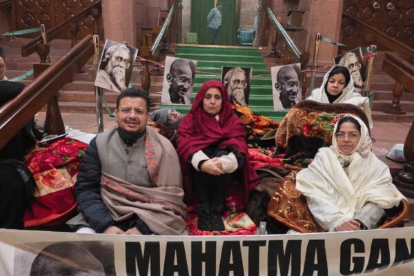 NEW DELHI: Opposition parties staged a 12-hour overnight dharna in the Parliament complex on Thursday night to protest the passage of the Viksit Bharat Guarantee for Rozgar and Ajeevika Mission (Gramin) Bill, or VB-G RAM G Bill, which replaces the Mahatma Gandhi National Rural Employment Guarantee Act.The protest came hours after Parliament cleared the Bill amid noisy scenes and walkouts. The Rajya Sabha passed the legislation post midnight by a voice vote, following its approval by the Lok Sabha earlier in the day, even as opposition members demanded its withdrawal and sought its referral to a parliamentary panel.Lok Sabha Passes Viksit Bharat G Ram G Bill Amid Protests, Opposition Tears Copies Over Gandhi NameOpposition MPs accused the government of rushing the Bill through without adequate debate and of scrapping a flagship rural employment scheme that, they said, supported crores of poor households. Several members walked out of the Upper House, raised slogans against the government and tore copies of the Bill, prompting repeated warnings from the Chair.Trinamool Congress Rajya Sabha deputy leader Sagarika Ghose alleged that the government had “bulldozed” the legislation. “This is an insult to India’s poor, it is an insult to Mahatma Gandhi, it is an insult to Rabindranath Tagore. With just five hours’ notice, this bill was given to us. We were not allowed a proper debate,” she said.“Our demand was such an important bill should be sent to the Select Committee and let the opposition parties examine it, let the opposition parties discuss it, let all stakeholders discuss it, but no, in a display of tyranny, in a murder of democracy,” Ghose said, announcing the overnight protest. “We are now going to sit on a 12-hour dharna, 12-hour dharna against the manner in which the Modi government has brought this black law against the people of India, against the poor of India, against the rural poor of India.”Congress general secretary Randeep Singh Surjewala described the development as a “sad day for the country’s labour force” and alleged that the government had hit the livelihoods of millions. “This is perhaps the saddest day for the labourers of India. BJP government has attacked the livelihood of 12 crore people by repealing the MGNREGA. They have proved that the Modi government is anti-farmer and anti-poor,” he said.Congress leader Mukul Wasnik said the original law was framed after extensive consultations. “When MGNREGA was drafted, consultations were held for 14 months. It was passed by Parliament with consensus. The scheme would put an extreme burden on states. As a result, this scheme will collapse,” he said.DMK leader Tiruchi Siva accused the government of erasing Mahatma Gandhi’s legacy. “Likewise they have removed Mahatma Gandhi’s name himself. Without Gandhi there is no freedom, that is the total belief in this country. Even in Britain parliament we are having Gandhi statue, but here in Indian parliament his statue is hidden somewhere, and now the scheme which bore his name, his name has also been removed,” he said.Defending the legislation, Rural Development Minister Shivraj Singh Chouhan said the new law was necessary to address shortcomings in the old scheme and to boost rural development. “This Bill is very necessary as it will help provide employment opportunities, help development of rural India and take the country forward,” he said while replying to the debate in the Rajya Sabha.Chouhan accused the Congress of misusing Mahatma Gandhi’s name for political gains and of disrupting parliamentary proceedings. “I heard the opposition with patience all these hours and expected the opposition to hear my response to the discussion. Making their points, making allegations and running away is like murdering the dreams and ideals of Mahatma Gandhi,” he said.“The entire nation is watching their ‘goondagardi’ and the opposition is committing the sin of insulting democracy. House ‘dadagiri se nahin chalega’,” the minister added.He also cited funding figures to defend the government’s record, claiming that while the previous UPA government released Rs 2.13 lakh crore for MGNREGA, the NDA had released nearly Rs 8.53 lakh crore. The opposition, however, maintained that the passage of the Bill without detailed scrutiny set a dangerous precedent and said it would take its protest against the law to the streets across the country.About the AuthorTOI News DeskThe TOI News Desk comprises a dedicated and tireless team of journalists who operate around the clock to deliver the most current and comprehensive news and updates to the readers of The Times of India worldwide. With an unwavering commitment to excellence in journalism, our team is at the forefront of gathering, verifying, and presenting breaking news, in-depth analysis, and insightful reports on a wide range of topics. The TOI News Desk is your trusted source for staying informed and connected to the ever-evolving global landscape, ensuring that our readers are equipped with the latest developments that matter most.”Read MoreEnd of ArticleFollow Us On Social MediaVideos’Abrupt Variation In Chenab River Flow’: Pakistan Cries Over Indus Water Treaty Suspension’Asking Since June…’: Priyanka Gandhi, Nitin Gadkari Share ‘Appointment’ Banter In Lok Sabha’Possibilities For Expansion’: Argentinian Envoy On Trade Partnership With IndiaCM Mamata Banerjee Renames West Bengal’s Job Guarantee Scheme ‘Karmashree’ After Mahatma GandhiNitish Kumar’s Hijab Shocker: BJP MP Giriraj Singh Defends Bihar CM’s Act With ‘Go To Hell’ RemarkIndia Flags Pakistan Role In Bangladesh Protests, Backs Awami League Demand For Free & Fair PollsIndia’s Silent Exodus: Over Two Lakh Indian Citizens Quit Passports Yearly Amid Changing AspirationsApache AH-64e And Prachand Give India A Two-Front Air Strike Edge From Deserts To High HimalayasLok Sabha Passes Viksit Bharat G Ram G Bill Amid Protests, Opposition Tears Copies Over Gandhi Name‘Worst Is Behind Us’: IndiGo CEO Says Airline Back on Track After Operational Crisis123PhotostoriesHow to grow peppers indoors for year-round fresh harvestsShah Rukh Khan’s ‘King’, Ranbir Kapoor’s ‘Ramayana’, Alia Bhatt’s ‘Alpha’, Deepika Padukone in Atlee’s film with Allu Arjun: Bollywood A-listers all set to make a splash in 2026Binging on midnight snacks? Late-night eating can damage your digestive system and affect heart and metabolic disease riskYubari King Melon: Japan’s most luxurious fruit costs ₹27,000 a piece; here’s why it’s so expensiveBreaking the link between smoking and lung cancer: Support for prevention and pain reliefKareena Kapoor Khan proves red is the only colour you need this ChristmasTop 8 dry fruits to boost immunity during the cold winter monthsJyotika’s unforgettable Bollywood moments from Doli Saja Ke Rakhna to ShaitaanDry mouth that won’t go away? Doctor explains if it is dehydration or something elseWinter’s hidden heart hazard: Why cold snaps spike attacks123Hot PicksTrump Gold CardUAE WeatherIndia Oman TradeGold rate todaySilver rate todayPublic Holidays DecemberBank Holidays DecemberTop TrendingTravis Kelce Retirement RumorsAnthony Richardson InjuryJaylen BrownWNBASan Francisco GiantsCam SkatteboPuka NacuaJake PaulSidney CrosbyMike Liaory