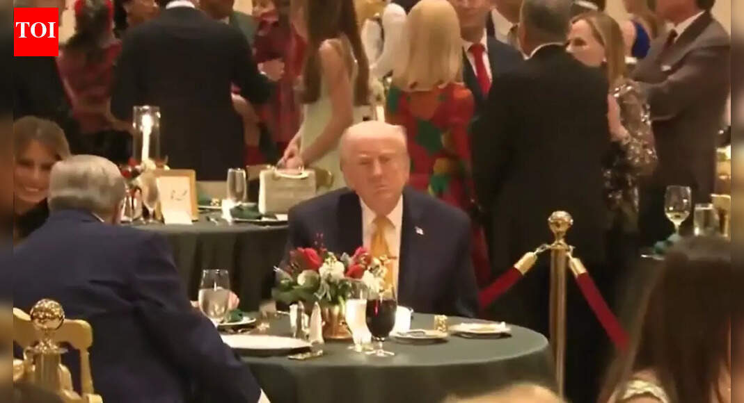‘Why are they sitting so far apart?’: Trump goes third wheel with Melania and her father Viktor Knavs at Mar-a-Lago Christmas dinner — Watch