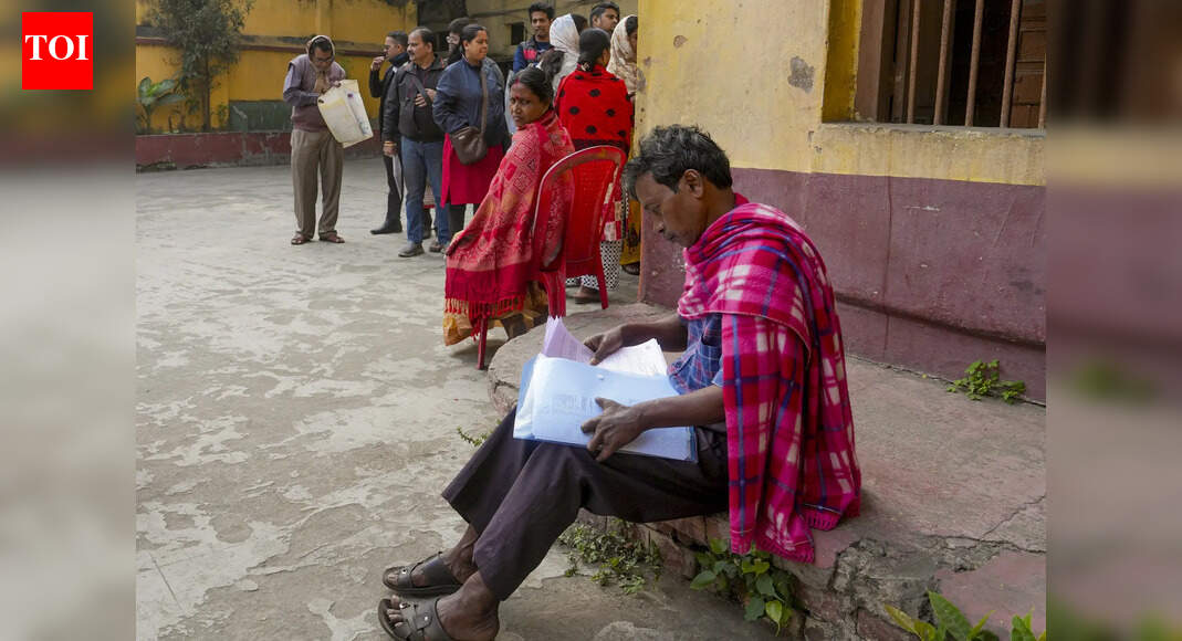 Kolkata: A man checks his documents at a school during a hearing under the Special Intensive Revision (SIR) of electoral rolls, in Kolkata, West Bengal. (PTI Photo/Manvender Vashist Lav)(PTI12_29_2025_000184B) Kolkata: SIR hearings in Bengal were disrupted in Chinsurah and Midnapore on Monday after EC said booth-level agents (BLAs) would not be allowed to be present during the proceedings, and an EC observer’s vehicle came under attack in Mograhat, South 24 Parganas.Special roll observer C Murugan, tasked with supervising SIR of rolls in South 24 Parganas and Kolkata South LS constituencies, had gone to Mograhat for a field visit when he encountered protests. Protesters allegedly damaged the handle lock of a door of the vehicle. EC has asked Murugan to submit a detailed report on the incident.The flare-up followed EC’s decision to debar BLAs from entering SIR hearings. Despite the protests, Murugan remained firm. “I came to do my job and I will do it. What do I have to fear? I am an IAS officer. I have come here on Election Commission’s instructions. It is the administration’s responsibility to provide me with security,” Murugan said.Around the same time, similar protests broke out in Hooghly and Midnapore. In Hooghly’s Chinsurah-Mogra block office, hearings were suspended after TMC MLA Asit Mazumdar objected to the exclusion of BLAs. “Unless BLAs are allowed or officials give in writing that they will not be allowed, we will not allow the hearings,” Mazumdar told reporters. Following this, gates of block office were closed, preventing people from entering.Later, after a prod from EC, the DM reached the spot and ensured that hearings resumed.End of ArticleFollow Us On Social MediaVideos‘We Will Win In The End’: Kuldeep Sengar’s Daughter Speaks After SC order On Unnao Rape Sentence’No Amount Of Finger Pointing…’: India Slams Pakistan Over Comments On Minorities In India’Blown Up In A Car’: Woman Threatens Asim Munir In Bradford Rally, Pakistan Summons UK EnvoyTurn Chicken’s Neck Into Elephant: Sadhguru Flags Siliguri Corridor As Strategic Weak Link’Won’t Spare A Single Infiltrator’: Amit Shah’s Poll Promise In Assam, Slams Cong Over InfiltrationUnnao Rape Survivor Welcomes Supreme Court Order, Says Legal Fight To Continue Till Sengar Is HangedSupreme Court Stays Its Order On Aravalli Definition, Environment Minister Welcomes Move’Called Minor Matter, Refused FIR’: Tripura Student Angel Chakma’s Father Blasts Uttarakhand PoliceAustralia, US And UK Raise Alarm Over Fake Rabies Vaccine As India Pushes Back On ClaimsShashi Tharoor Slams Racial Attack and Murder of Tripura Student In Dehradun As ‘National Disgrace’123PhotostoriesInspiring stories of kids who made headlines in 20256 types of Dhoklas to try at home‘Bigg Boss’ 19 fame Tanya Mittal’s accessory game is LIT: From pearl choker to kundan necklacesBharti Singh and newborn son Kaju receive a grand welcome home as family decorates the house for ChristmasFrom Smriti Mandhana-Palash Muchhal to Celina Jaitly-Peter Haag: 7 celebrity break-ups and divorces that shocked fans in 20255 times OpenAI CEO Sam Altman showed that fatherhood comes first9 national parks in India that are best explored on footWould you drive on these dangerous and unusual highways?Winter Special: How to make Matar ki Kachori for dinnerTV stars who ruled the headlines in 2025: From Gaurav Khanna to Tejasswi Prakash123Hot PicksSilver price todayPAN-Aadhaar linkingCristiano RonaldoGold rate todayIncome Tax RefundIndian Railways fareBank Holidays DecemberTop TrendingErika KirkTravis KelceCandace OwensRobert Kraft & Gayle Benson Net WorthNick ShirleyDraymond GreenMicah Parsons ACL SurgeryAnthony Davis vs Luka Doncic Salary ComparisonBoogeyman WifeNew York Yankees