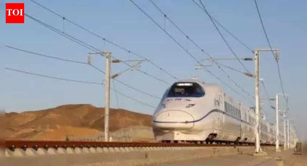 Photo credit: IANS NEW DELHI: A delay of over four years has pushed up the cost of the country’s first Bullet Train project by around 83% to Rs 1.98 lakh crore. The first leg of the project, between Surat and Bilimora, is scheduled to be inaugurated in Aug 2027, while the entire 508-km corridor is likely to be completed by Dec 2029.Responding to a question on the cost escalation for the Ahmedabad-Mumbai High Speed Rail Corridor project being implemented by NHRSCL, at a briefing on govt’s Pragati initiative, Railway Board CEO and chairman Satish Kumar said, “While the final sanction for the revised cost is yet to be taken, it’s around Rs 1.98 lakh crore. It’s still under revision… It will be finalised within a month or two.”Initially, the project was sanctioned at a cost of around Rs 1.1 lakh crore. The project has faced time and cost overruns due to different reasons, including delay in land acquisition, statutory clearances and finalisation of the rolling stock (trains).In a statement last week, railways said that overall physical progress in the project stood at 55.6% until Nov 30 and financial progress at 69.6%. Until Nov end, Rs 85,801 crore had been spent on the project. TOI has learnt that PM Narendra Modi, while reviewing work of railway ministry last month, had directed it to expedite completion of the project.Earlier on Friday, railway minister Ashwini Vaishnaw virtually witnessed from Rail Bhawan the final breakthrough in a 1.5-km-long mountain tunnel, a part of the project, in Maharashtra’s Palghar district. “A big milestone has been achieved today (Friday). This achievement is the breakthrough of the mountain tunnel 5,” he said.In an official release, the ministry said that it is among the longest in Palghar district, being located between the Virar and Boisar bullet train stations. “It is the second tunnel breakthrough in Maharashtra, as the first 5-km-long underground tunnel between Thane and BKC was completed in Sept 2025,” it said. The project passing through Gujarat, Maharashtra, and Dadra and Nagar Haveli is designed to operate bullet trains at a speed of 320 kmph.The corridor will also be fit for operating the advanced Japanese E10 series Shinkansen trains as it is being designed to allow trains to run at 20 kmph higher speed. Once completed, the corridor will lead to an estimated reduction of nearly 95% in carbon dioxide emissions compared to road transport.End of ArticleFollow Us On Social MediaVideosShankh Air Founder Speaks Out As Airline Eyes March Launch, Targets Intl Flights By 2029’Their Islamist Ideas…’: Ex-Bangladesh Minister Hits Out Over Attacks on Hindus And Christians’Very Petty & Shameful’: Shashi Tharoor On Row Over KKR Selecting Bangladeshi Player In IPLINLD President Calls For Sri Lanka, Bangladesh, Nepal Type Uprising In India Politics, Triggers RowBJP Claims Rahul Gandhi Ties To ‘Anti-India’ Panel Over US Lawmakers’ Umar Khalid LetterNot All Are Illiterate: Rajnath Singh Cites Red Fort Blast, Flags Educated, White Collar Terrorists’Arunachal Pradesh Is And Will Always Be…’ Jaishankar Warns China, Blasts Harassment Of IndiansBullet Train Gets August 15, 2027 India Launch Date, Minister Shares Details On Tunnel BreakthroughCleanest City Hit By Water Contamination As Lab Links Indore Diarrhoea Outbreak To Pipeline LeakUS Lawmaker Raja Krishnamoorthi Condemns Violence Against Hindus In Bangladesh Urges Global Action Up123PhotostoriesHow to make Andhra-Style protein-rich Green Moong Dosa for breakfastWhich Color to Wear on Full Moon Based on Your Birth Date?6 stunning flowering succulents that will transform your balconyWhy your fish keeps dying: 5 mistakes most aquarium owners make without realising7 foods to combine with sweet potato for a wholesome breakfastOlder people who live happily, do these 10 things in their 30 and 40s8 winter pickles to add warmth and taste to your mealsLessons from centenarians: What the world’s longest-living people eat‘Shark Tank India Season 5’: FULL LIST of judges, their net worth, and the brands they ownKylie Jenner-Timothée Chalamet to complete 3 years of dating in 2026: 3 relationship lessons to learn from them123Hot PicksPremarital Test OmanVande Bharat Sleeper TrainJanuary Bank holidayGold rate todayIncome Tax RefundBahrain Golden Visa 2025Bank Holidays DecemberTop TrendingSan Francisco 49ersBrittany MahomesNoah Lyles and Junelle Bromfield Net WorthWayne Gretzky Daughter Net WorthSidney Crosby LifestyleLeBron James vs Stephen Curry Net WorthTom BradyLeBron James WifeCam ThomasCharlie Kirk