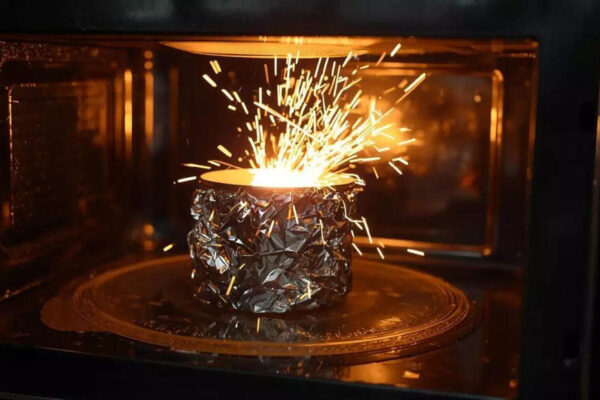 Why does aluminium foil spark in a microwave but not in an oven |