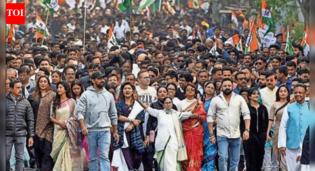 West Bengal CM Mamata Banerjee leads a protest rally from Jadavpur to Hazra Crossing against ED raids on I-PAC office in Kolkata KOLKATA: Coinciding with its fight against ED over searches on I-PAC, Trinamool Congress released on Saturday a three-minute campaign song and music video titled ‘Jotoi koro hamla, abar jitbe Bangla’ (Attack as much you can, Bengal will win) to galvanise workers ahead of the Bengal elections this summer.The song has echoes of TMC’s 2021 campaign theme, “Bangla nijer meye-kei chaye” (Bengal wants its own daughter), in a reference to chief minister Mamata Banerjee. This time, weaving “Bengali asmita” (pride) into its campaign narrative, the video outlines TMCs core campaign planks in the run-up to the polls. BJP Targets Mamata Banerjee Over ED Raid At I-PAC, Alleges Evidence Tampering The video highlights attacks on religion and Bengali language, stressing that the political battle is also about “saving Bengal’s plurality” both in religion and personal choices. Protests against attacks on Bengali-speaking migrants also feature in the clip.According to a TMC senior, two images spell out the narrative for party workers. One is Mamata’s fighter perception, reinforced by a split-second image in which she transforms into a Royal Bengal tigress. The second is the positioning of black-and-a-white images of PM Narendra Modi and Union home minister Amit Shah – to mark out the key adversaries.The campaign this time is a repositioning of TMC’s 2024 Lok Sabha election theme, “Jonogoner Gorjon, Banglay BJPer Bisorjon” (Roar of the people, BJP’s ouster from Bengal), TMC’s senior functionaries said.TMC had first used this theme ahead of the 2021 assembly elections, a contest that came with a series of firsts for Mamata. “This was the first time she contested from a seat outside Kolkata. It was the first time she had to deal with poll-eve defections on a large scale, including two senior ministers led by Suvendu Adhikari,” a TMC senior said.Listing the other milestones, the senior pointed out that it was the first time that Mamata led an entire 50-day election campaign, “not on her feet but on a wheelchair” after she was injured in a pre-poll car mishap. “It was the first time she had allowed a poll strategist to recalibrate her political strategy,” the senior said, alluding to I-PAC founder Prashant Kishor.End of ArticleFollow Us On Social MediaVideosIndia-EU FTA: Piyush Goyal Wraps Up Brussels Visit; Push To Accelerate Trade Deal Talks’Hope India Backs Denmark’: Danish MP Urges Delhi’s Support Amid Trump’s Greenland ThreatsOdisha Plane Crash: Nine-Seater Aircraft Crash-Lands Near Rourkela, 6 InjuredWhy Nations Fight Wars: Ajit Doval Breaks Down Power Game, Morale, Western Fear And India’s Rise’They Amended UAPA’: Owaisi Blames Congress For Umar Khalid And Sharjeel Imam’s Jail Without Trial’No Courage, No Strength’: Lt Gen Katiyar Ridicules Pak, Exposes Terror Strategy, Warns Against War’Hijab-Clad Woman As India’s PM’: Owaisi’s Remark Gets ‘Hindu Nation’ Retort From BJP’s Nitish Rane’India Will Develop Even On Autopilot’, Says NSA Ajit Doval As He Credits PM Modi’s LeadershipHindu Farmer Killing in Sindh Triggers Protests A Day After India Exposed Pak’s Record on MinoritiesDefence Spending Can Fuel Growth, Says CDS Anil Chauhan As India Rethinks Guns Versus Butter Debate123PhotostoriesHow to make South Indian Onion Uttapam for breakfast8 plants that bring calm, luck, and positive energy to your home10 phrases to avoid before sending your child to school (and why)3-ingredient thick hot chocolate recipe for cosy winter nightsNupur Sanon and Stebin Ben’s romantic pictures together ahead of the dreamy wedding7 winter ladoos packed with protein that actually keep you fullStebin Ben’s most romantic songs that will make you fall in love with the singerTop motivational series to watch on OTTNupur Sanon best ethnic looks: A glimpse at the bride-to-be’s most stunning fashion momentsLittle verses, lasting values: Why shlokas matter in a child’s early years123Hot PicksTrump tariffsUS Supreme CourtGold rate todayBengaluru newsCigarette price hikePublic holidays January 2026Bank Holidays JanuaryTop TrendingCandace OwensBill KennedyDonald TrumpVanessa BryantJaipur Audi AccidentDrew McIntyreAndhra Pradesh Student Missing in USWasim AkramWPL Live ScoreStefon Diggs