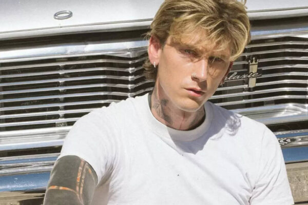 Machine Gun Kelly shows off new ear tattoos at Clive Davis Grammys party