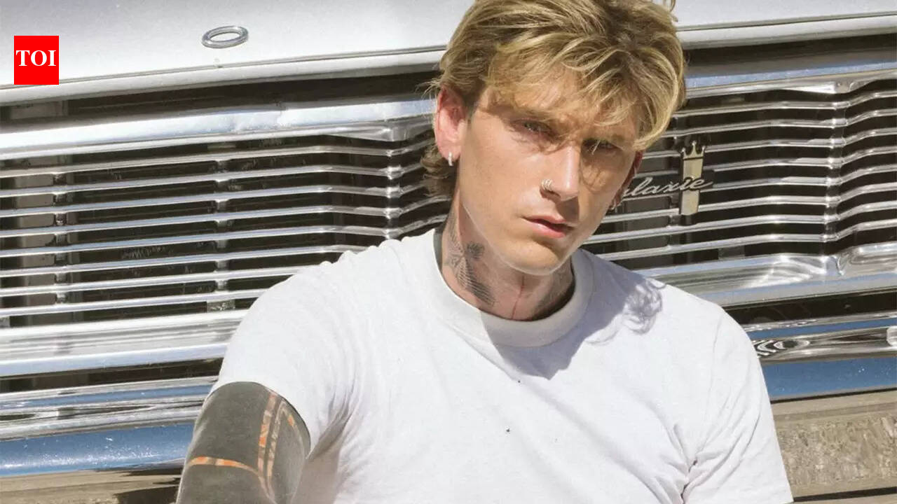 Machine Gun Kelly shows off new ear tattoos at Clive Davis Grammys party