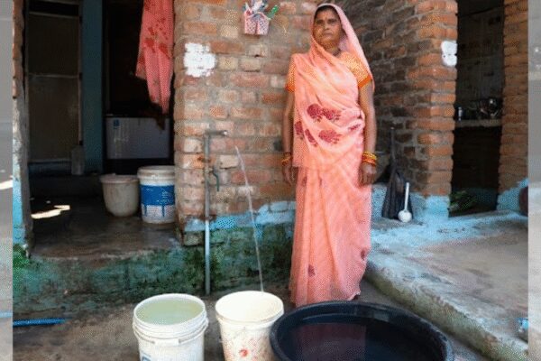 – LUCKNOW: For the people of Bundelkhand, this is nothing short of a dream come true that water is now available inside their homes. There are countless stories of hunger, poverty, and hardship linked to water scarcity in this region.The image of a woman carrying a pot of water on her head from faraway places had, for years, become the very identity of Bundelkhand’s districts.For decades, women here endured the water crisis. They walked long distances to reach remote wells and stood in queues at handpumps to collect water. But all this is now part of the past. Today, water tanks visible from afar stand as flowing streams of hope.This scene in Bundelkhand can captivate anyone. In Marwari Gram Panchayat of Panwari block in Mahoba, a woman adjusts her veil outside her house and fills a bucket with water from a tap, while a six-year-old child stands nearby holding a glass. The happiness on the woman’s face says everything about what this tap means to her.When asked, she replies shyly, “Brother, a big crisis has been removed.” When asked whether water comes regularly, her enthusiasm is evident. “Yes, why not. It comes every day.”When asked who all have tap connections, the village head standing nearby explains in detail, “Everyone in the village has it. Water comes twice a day. One tap connection is public, where anyone passing by can drink water.”Talking about Mahoba, the people here had long endured extreme hardship due to water scarcity. At one point, water had to be supplied through water trains. People wandered far and wide just to fill a single pot of water. Now, water tanks visible from a distance tell a completely new story.Under the Jal Jeevan Mission, through five projects, pipeline connectivity has been provided to more than 1.12 lakh households in the district. However, this large-scale scheme did not take shape easily. About 1,131 kilometers of roads were damaged during the work. While repair work was carried out, people did face some inconvenience.Arshad from Mahoba says that whenever a scheme begins, some inconvenience is inevitable, but “Har Ghar Nal” has emerged as a very big hope for this region.In Chitrakoot, under the Silauta Gram Mustakil Group Scheme, the water problem of about 1.25 lakh people in the development blocks of Pahadi, Ramnagar, and Manikpur has been resolved. The hardship of Manikpur’s residents can be understood from the fact that they earlier had to bring water from nearly one kilometer away.Because of this problem, people were often reluctant to marry off their daughters. For them, this water means life itself and the future of their children.Under the scheme, a total of 576 km of pipeline was planned, of which 572 km has already been laid. There are 17 overhead tanks, where water is brought daily from the water treatment plant. Water is drawn from the Yamuna River, treated at the plant, lifted into tanks, and then supplied to people’s homes.Smt. Rajjan Devi, the village head of Barhat, becomes emotional while talking about this scheme. She says, “We are grateful to the Yogi-Modi government for making arrangements to protect our children from diseases. Our children now bathe and go to school. A sense of cleanliness has automatically developed in them.”Along with Silauta, Raipura and Chandi Bangar group drinking water schemes are also being implemented in Chitrakoot. These schemes represent streams of hope that people had never even imagined.Under the Raipura Gram Samuh Peyjal Yojana, the target was to provide tap water to 19,570 families. Taps have been installed in all these houses, and water supply has begun in 60 revenue villages.Chunbad Yadav, a resident of Madna village covered under the scheme, says that a major problem has been resolved. Arranging water even for daily use was difficult earlier, and water for livestock was out of the question. Now they no longer have to worry.This may appear to be just about a tap, but for Bundelkhand, it is a blessing. It represents the fulfillment of a resolve that the Modi-Yogi government undertook as a mission.In Jhansi district, Jal Jeevan Mission pipelines have reached even the last-mile villages in Bada village, Chirgaon, and Bangra.Kamta Prasad, a 65-year-old resident of Gairaha Gram Panchayat in Bangra block, becomes emotional and says that his eyes had longed to see this day.Shagun, a married woman from this village located far from the district headquarters, says ‘earlier she had to walk half a kilometer outside the village to fetch water, and the situation became extremely difficult during the rainy season’.In Pachwara Gram Panchayat of Bangra block, when Ragini came as a daughter-in-law, she had to fetch water from a government handpump. Today, she proudly turns the tap and shows how clean the water is.The daughter-in-law of a poor family is happy that her husband Mukesh Kumar, a daily wage laborer, did not have to pay even a single rupee for the tap connection.Village head Akhilesh Rawat says, ‘about one thousand connections have been provided in his village’. In this Dalit-dominated village, the Arogya Mandir built during the Yogi government also has a tap connection under the Jal Jeevan Mission, ensuring clean drinking water for patients and attendants. Government schoolchildren are also now drinking clean water.Executive Engineer of the Jal Jeevan Mission, Ranvijay Singh, says that 42 villages are covered under this scheme, with 11,437 connections provided.Earlier, the very mention of Banda would bring to mind drought, water scarcity, and thirst. Now, through the Amlikaur Drinking Water Project and the Khatan Drinking Water Project, water has reached 544 villages, and 82,266 households have been provided connections.Pardeshi, a resident of Bandha Purwa village in Badokhar Khurd block says, ‘earlier they struggled a lot for water, but now they are receiving clean water inside their homes’.Executive Engineer of Jal Nigam, Vimal Kumar Verma says, ‘that roads dug up for pipeline laying have also been repaired’.In Hamirpur district as well, two drinking water projects are underway, through which tap water is being supplied to homes in 320 out of 322 villages. For the people here, this scheme is set to play a very significant role in transforming daily life.End of ArticleFollow Us On Social MediaVideos‘India Has A Preference Over…’: Piyush Goyal On US Trade Deal, Trump’s ‘Russian Oil’ Claim‘Embarrassed Himself’: Gaurav Gogoi Slams Assam CM Himanta Sarma Over ‘Pakistan Links’ Allegation‘1.25 Crore Hindus In Bangladesh’: RSS Chief Mohan Bhagwat Issues Big Unity CallUkraine to Gaza: Malaysia PM Anwar Ibrahim hails PM Modi’s unwavering global peace pushGogoi’s wife Elizabeth worked for Pakistani agent Ali Tauqeer Sheikh: Assam CM Himanta Biswa Sarma‘India’s Stand on Terrorism Is Clear’: PM Modi Speaks Firmly During Malaysia Visit”Strategic Ties And Trade Strengthened”: PM Modi Exchanges MoUs With Malaysian PM’Reasons For Reducing Russian Oil Imports Are…’ Foreign Expert Explains India-US Trade FrameworkIndia Reiterates Energy Security Priority, Signals Russia Oil Imports Will ContinueGhaziabad Sisters’ Deaths: Father’s Three Marriages Add Twist To Probe123Photostories5 Vastu-approved plants you should bring to your home today for prosperity7 brutal truths about starting a business no one warns you about5 effective ways to keep spiders away from your home and garden (third is a magical remedy!)Top 6 cheapest destinations to travel in India in 2026The one-sided friendship problem: Why so many adult friendships feel draining now8 types of kadhi from across India to try for lunchScarlett Johansson net worth: Inside the USD 165 million fortune of Marvel’s ‘Black Widow’ starFrom Bad Bunny, Green Day to Charlie Puth: Full list of Super Bowl 60 performersFrom a massive living room to lavish bedrooms: A look at Samay Raina’s luxurious housePM Narendra Modi’s Panch Prana goal and the role of Shatavari and it’s importance in traditional Indian kitchens123Hot PicksBudget 2026Gold Silver PricesParliament Budget SessionGCC Unified Visa 2026Income Tax CalculatorPublic holidays February 2026Bank Holidays februaryTop TrendingFortnite Love EventBoston Celtics vs New York KnicksLindsey Vonn InjurySuper Bowl LX TicketSuper Bowl PredictionsJustin GaethjeLIV GolfLiam Paro vs Paddy Donovan Net WorthWinter Olympics 2026NBA Trade Update